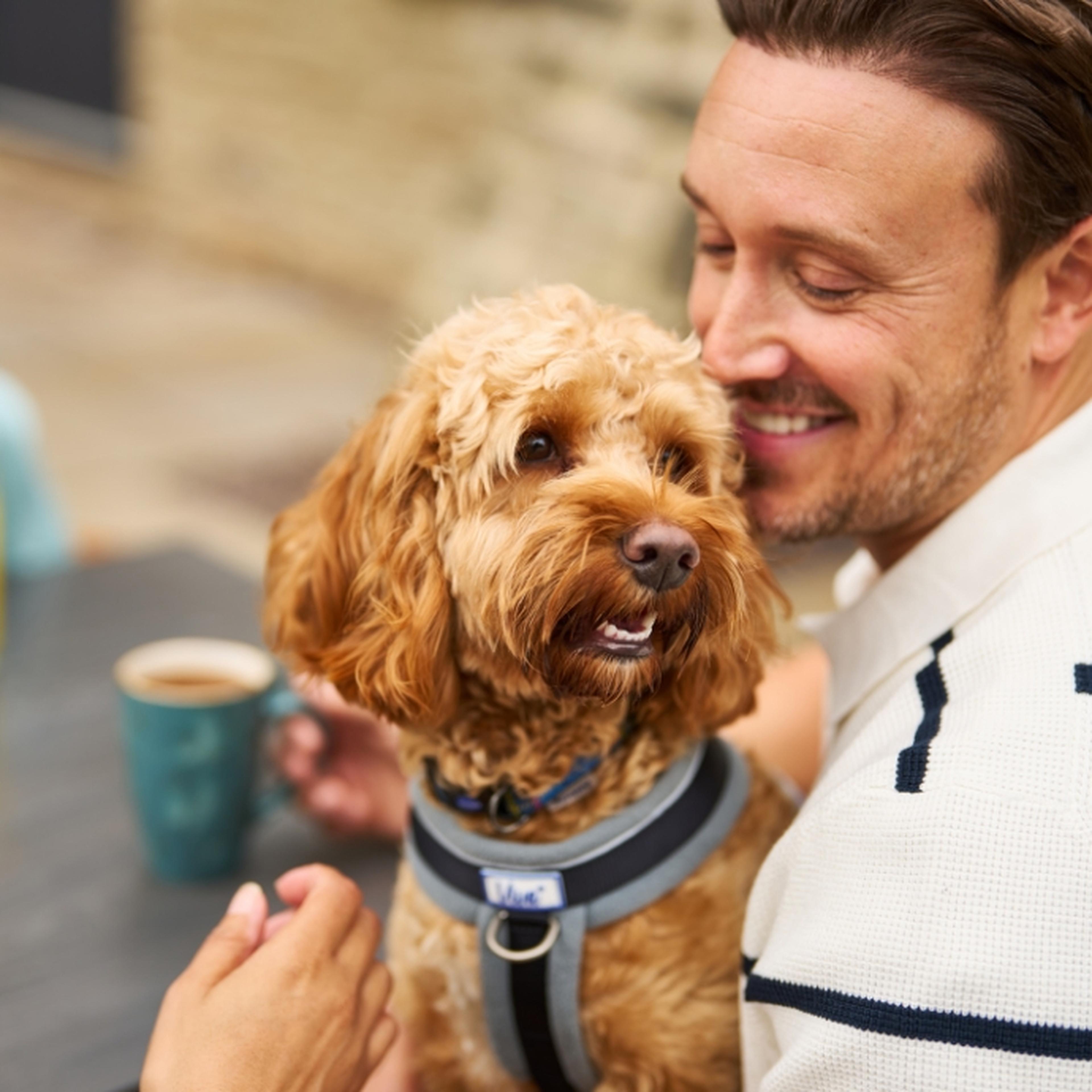 Man outside Whitemead Forest Park Café with dog
