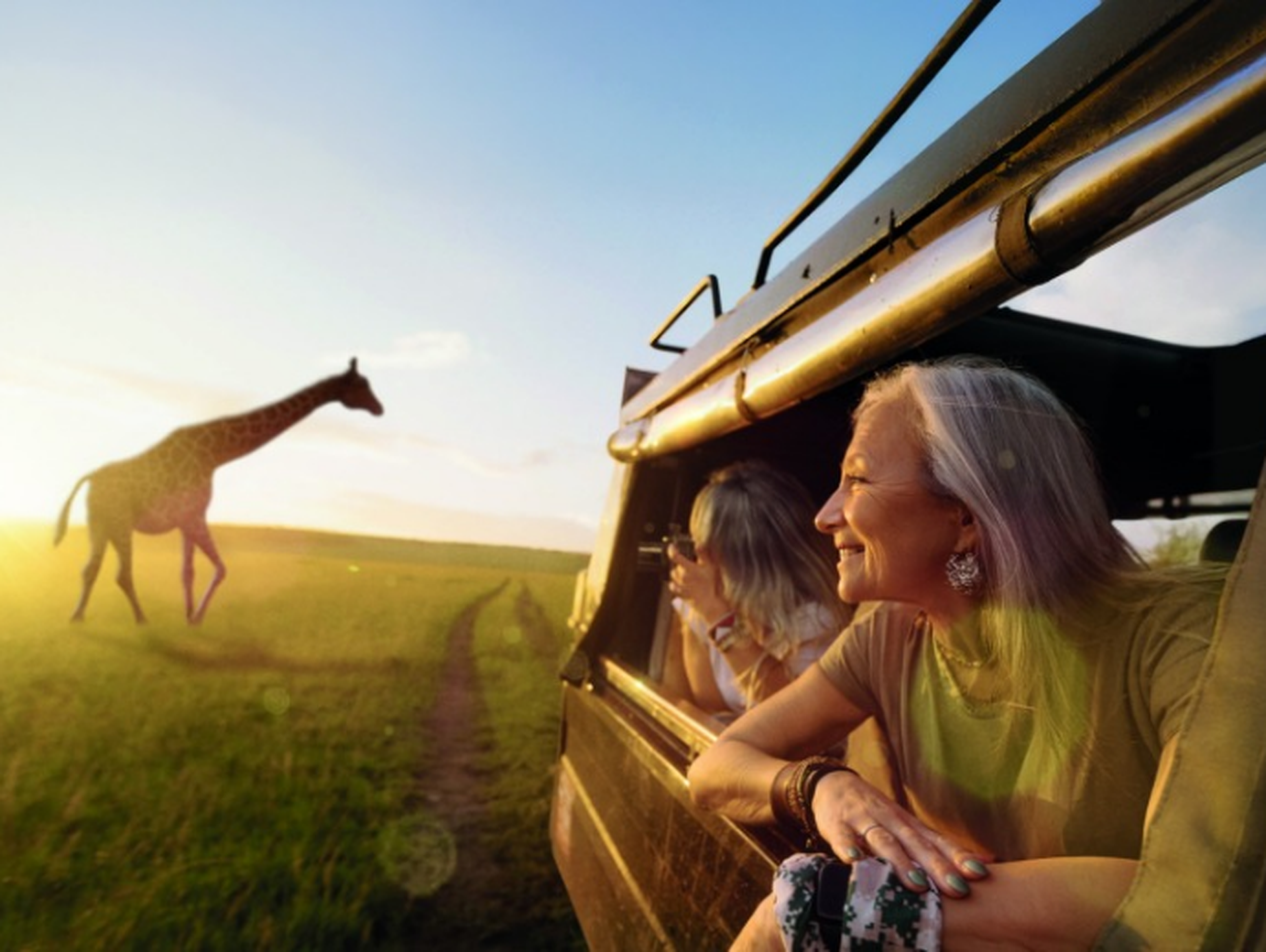 Woman on safari looking at a giraffe