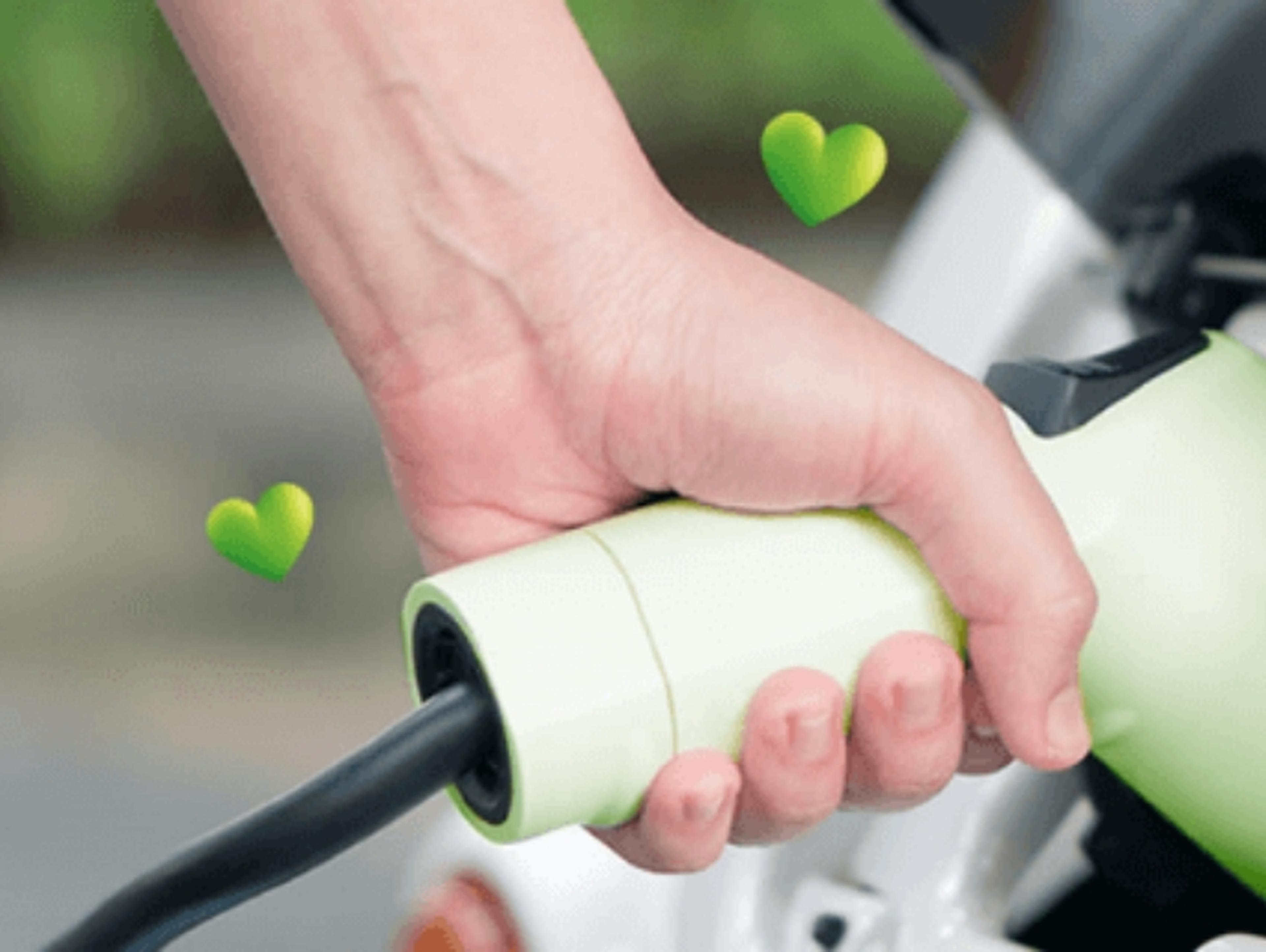Close up of a hand connecting an electric vehicle