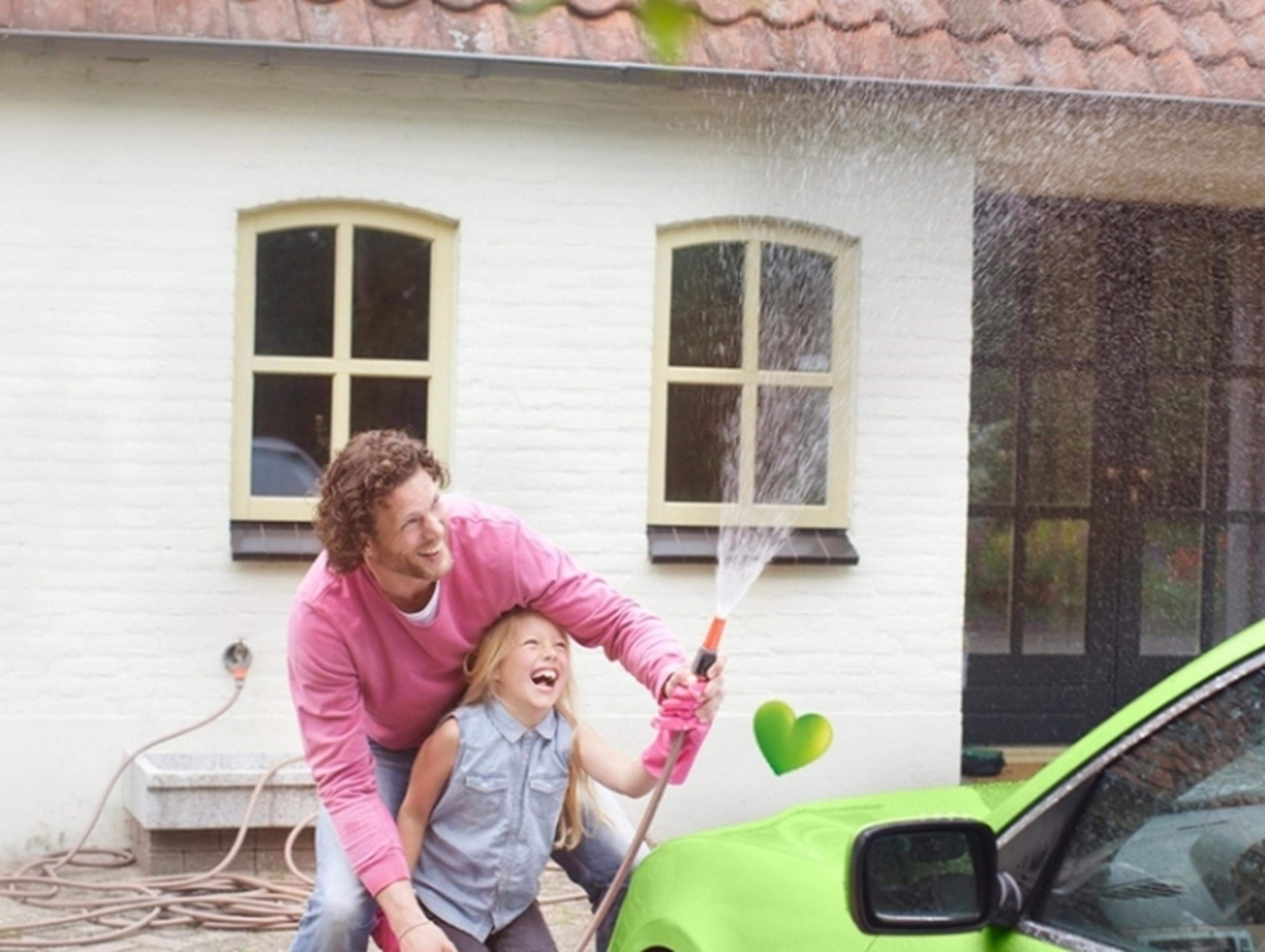 Man and child washing a car