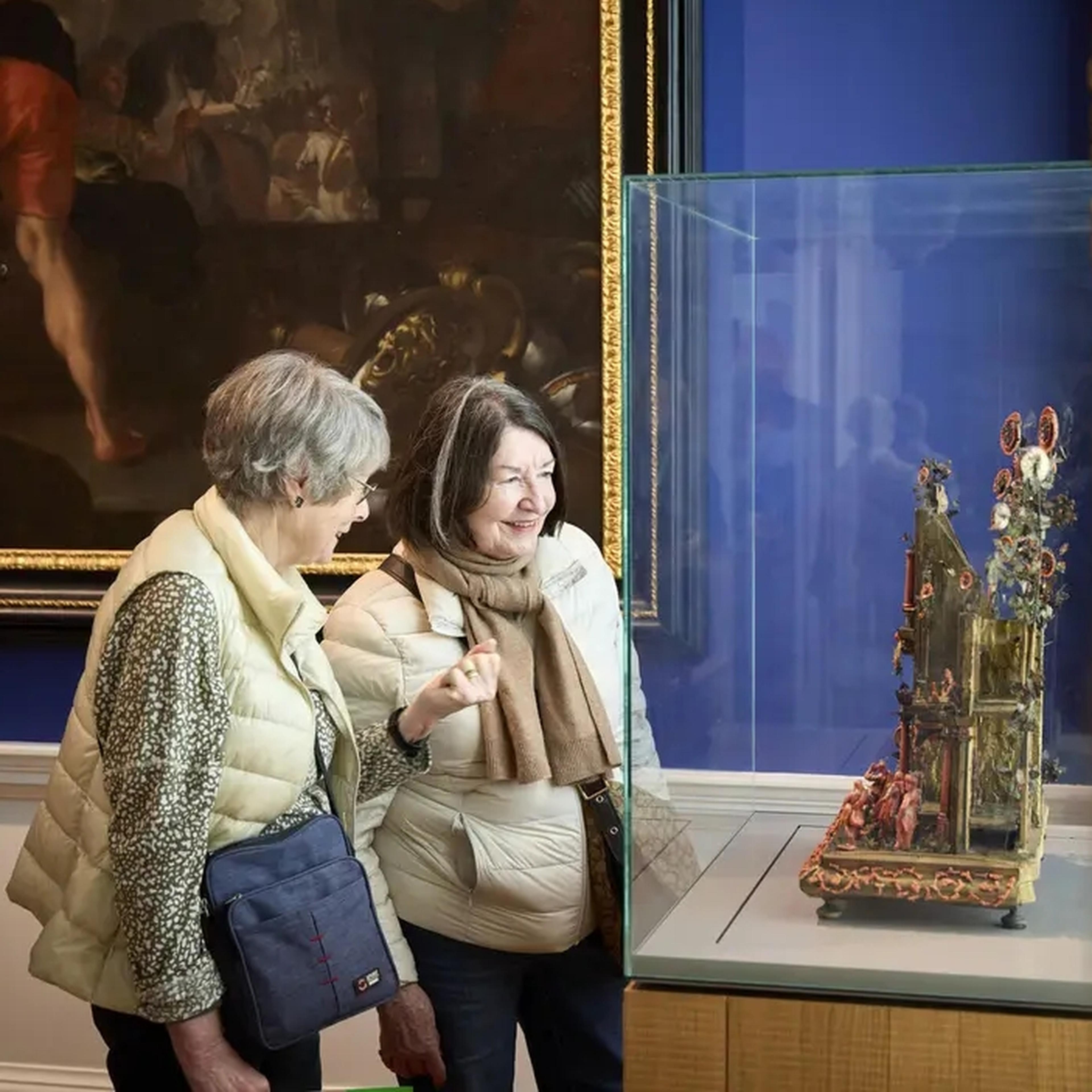 Couple of visitors looking at art