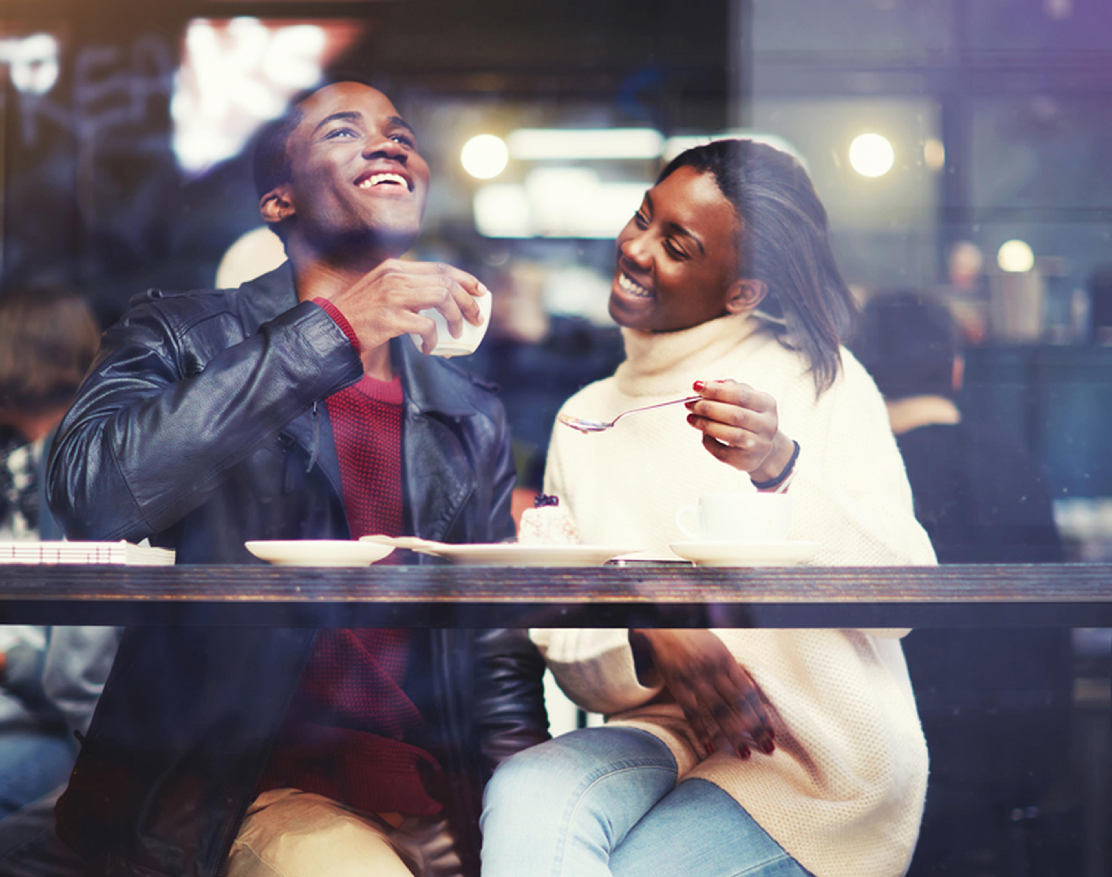 Happy couple enjoying coffee and dessert at caffe nero
