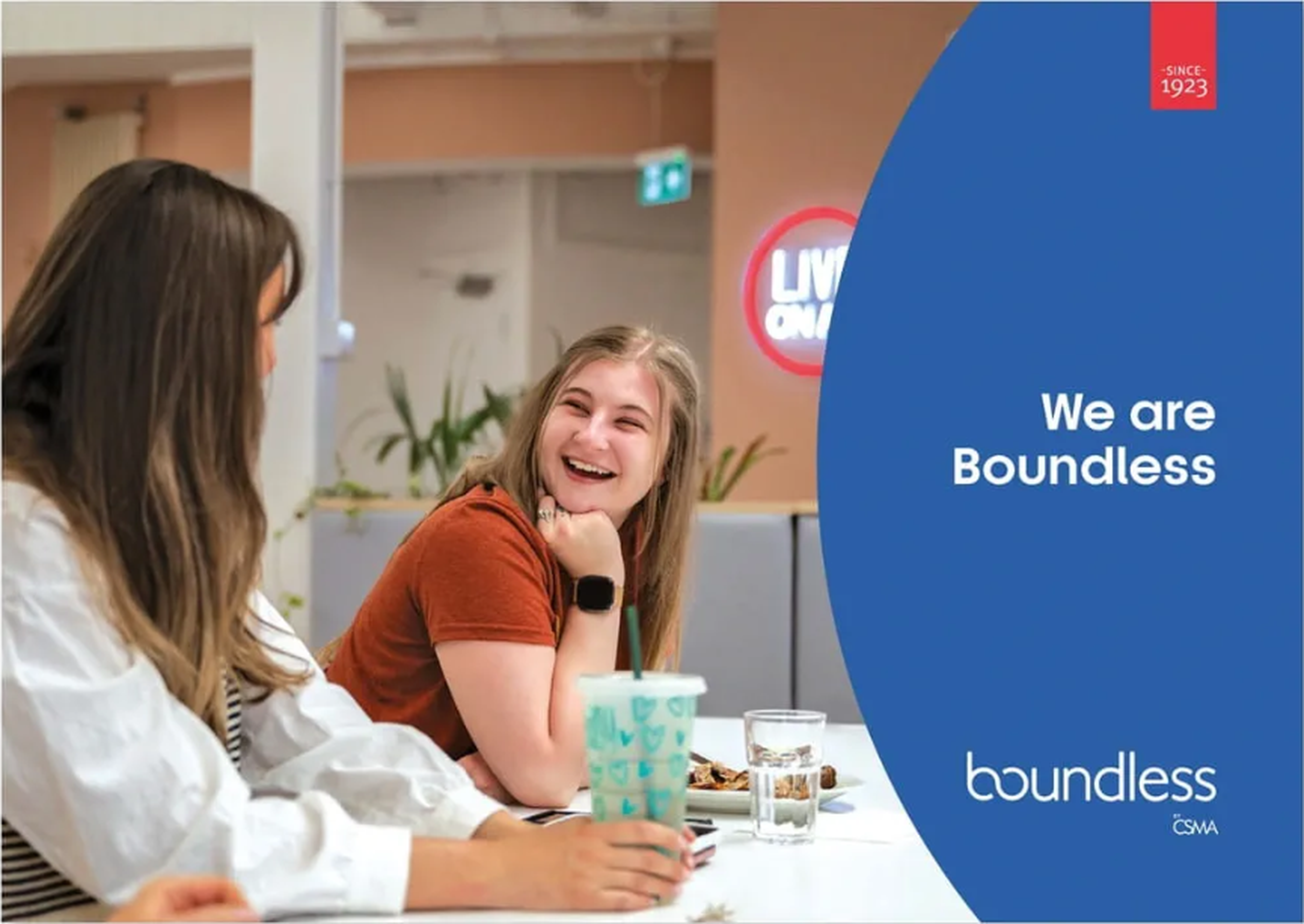 Two women smiling and talking at a table. Text on a blue background reads, "We are Boundless."
