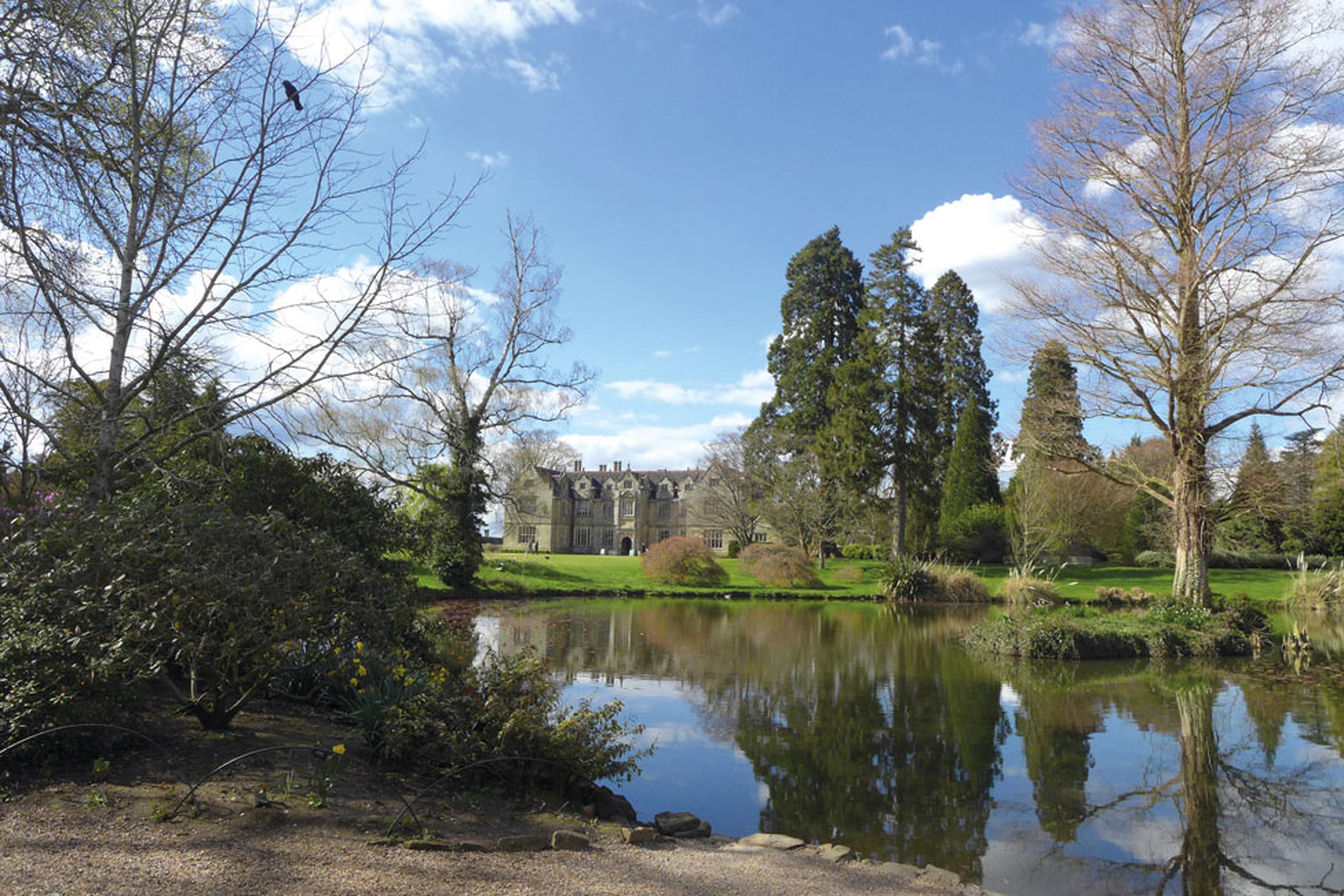 The lake and view of Wakehurst house and gardens.