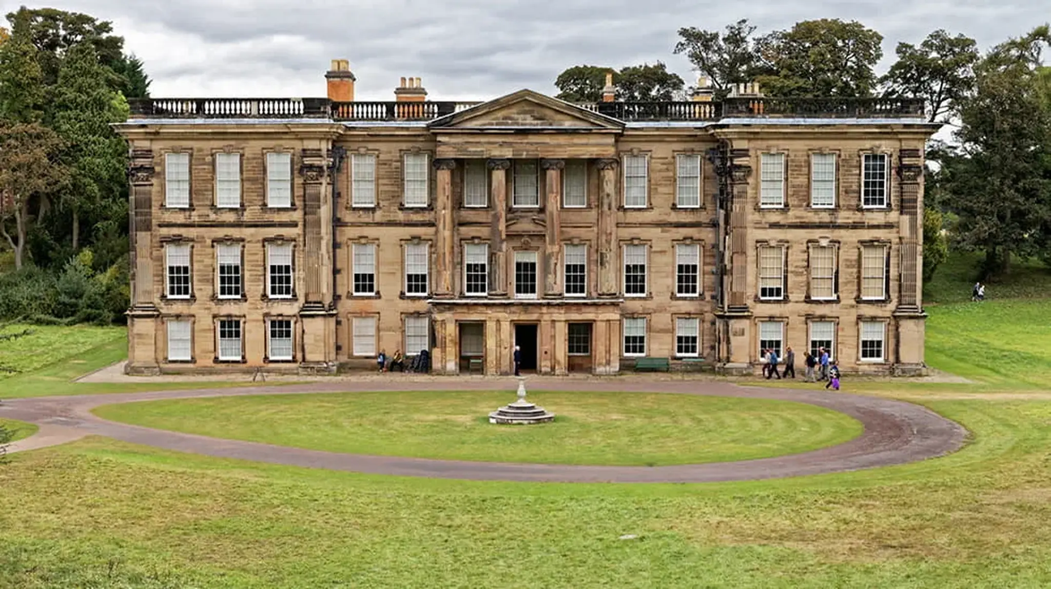 A large, stately mansion with columns and numerous windows