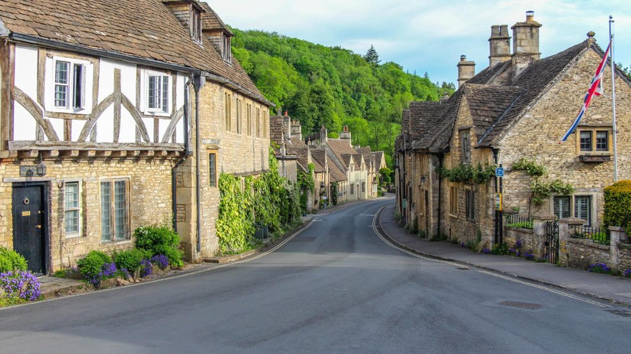A quaint village street lined with Cotswolds stone cottages
