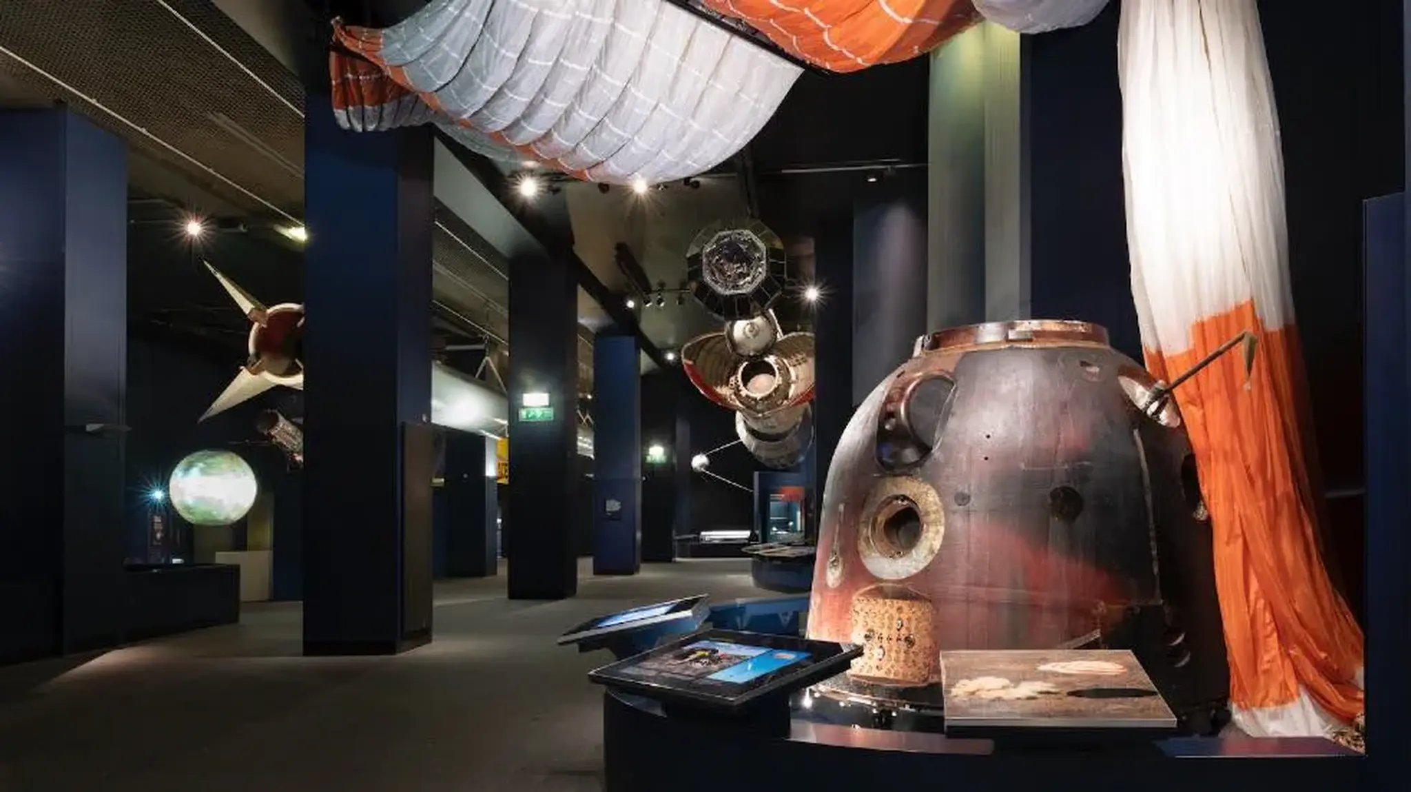 London Science Museum exhibit featuring a space capsule, engines, and spacecraft models