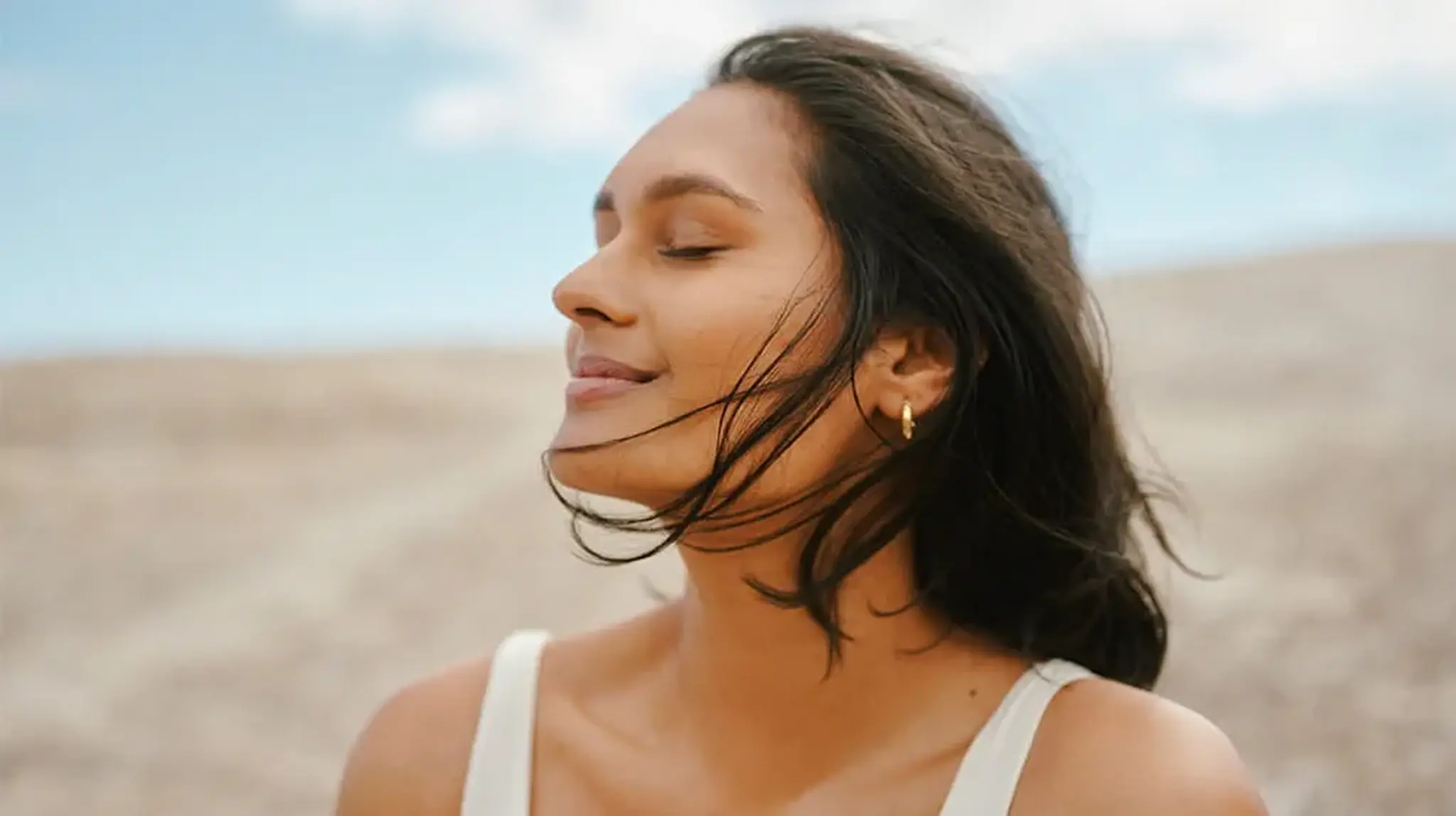 Woman with eyes closed, smiling peacefully