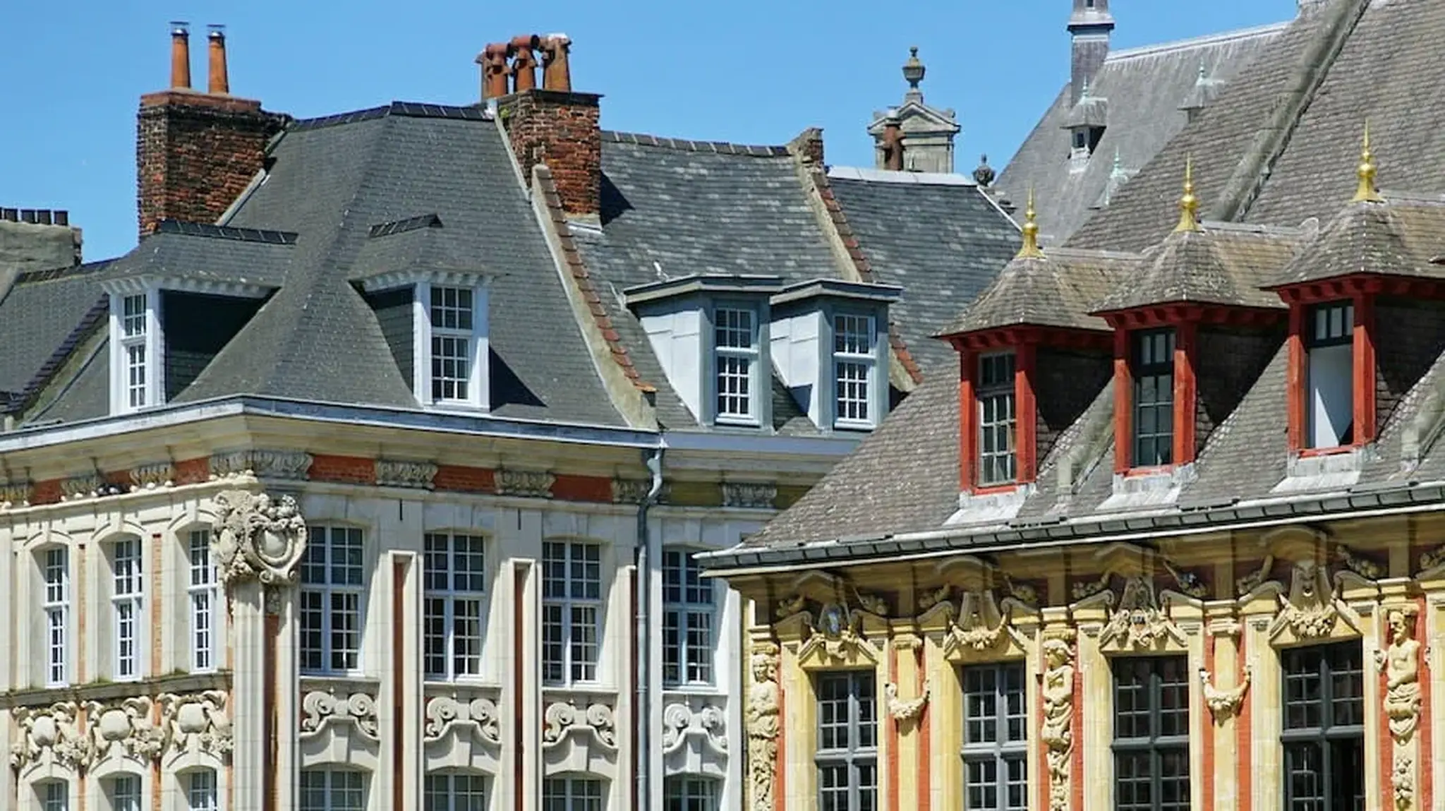 Ornate historic buildings with intricate facades and steep roofs