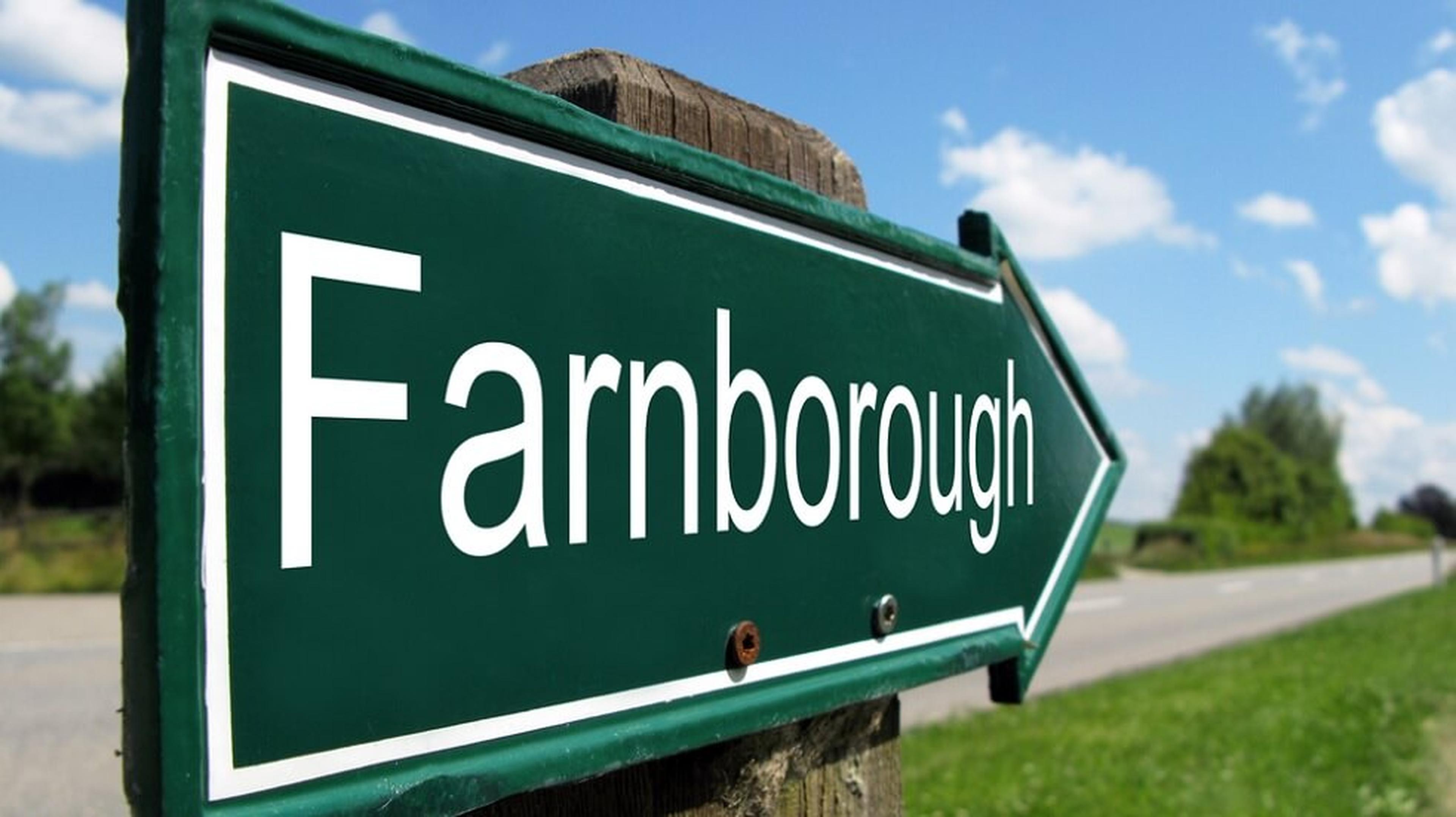 Green road sign with the word "Farnborough" and an arrow pointing right