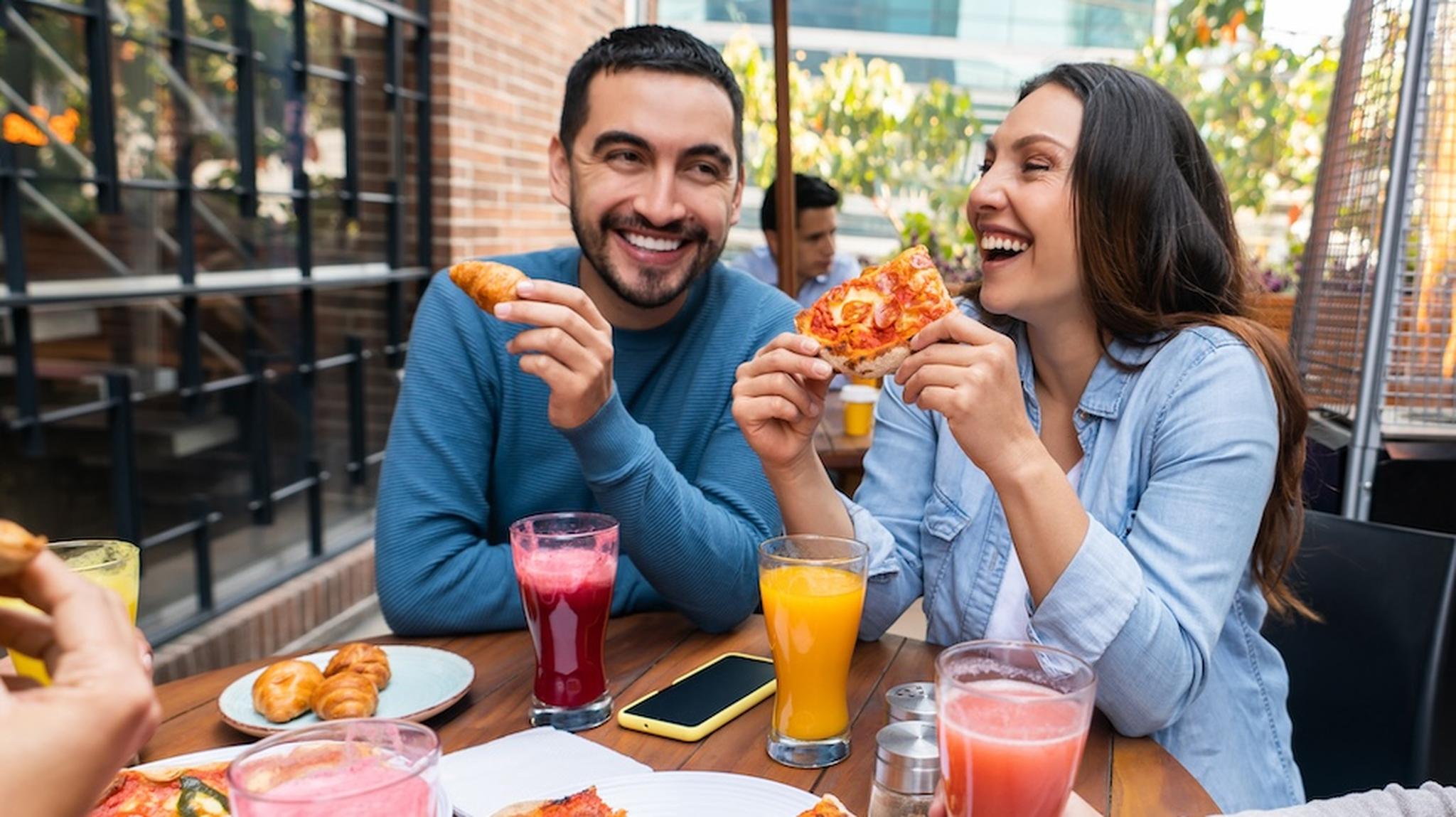 Man and woman eating meal outdoor dining
