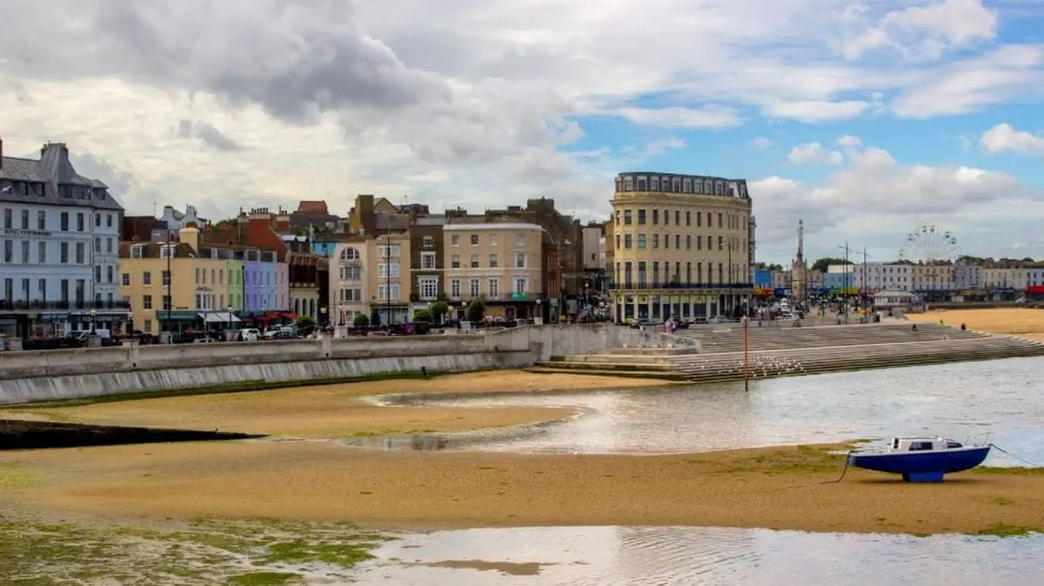 Margate coastal town view with sandy beach, moored boat and historic buildings