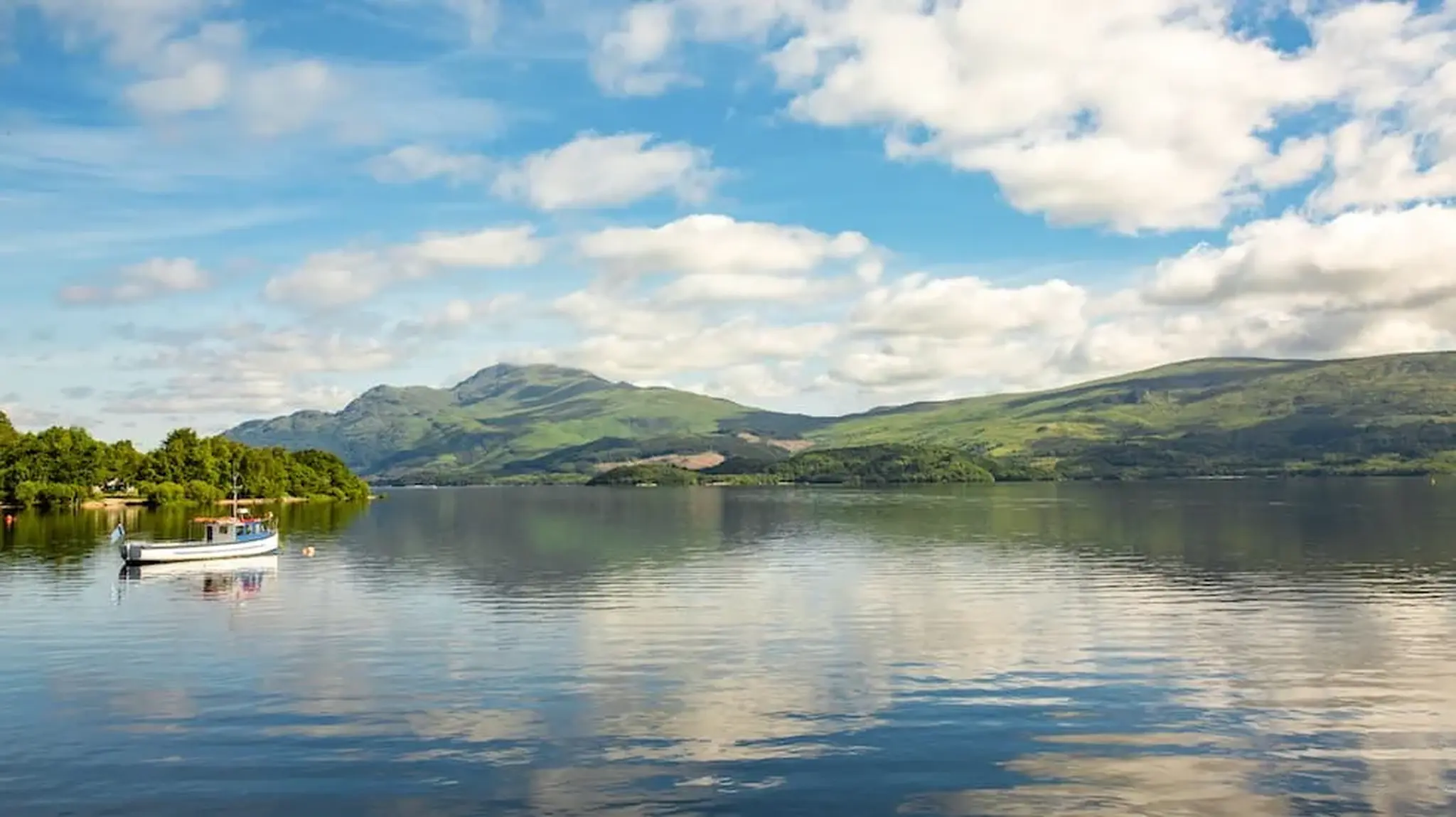 Serene lake scene with a small boat on calm waters