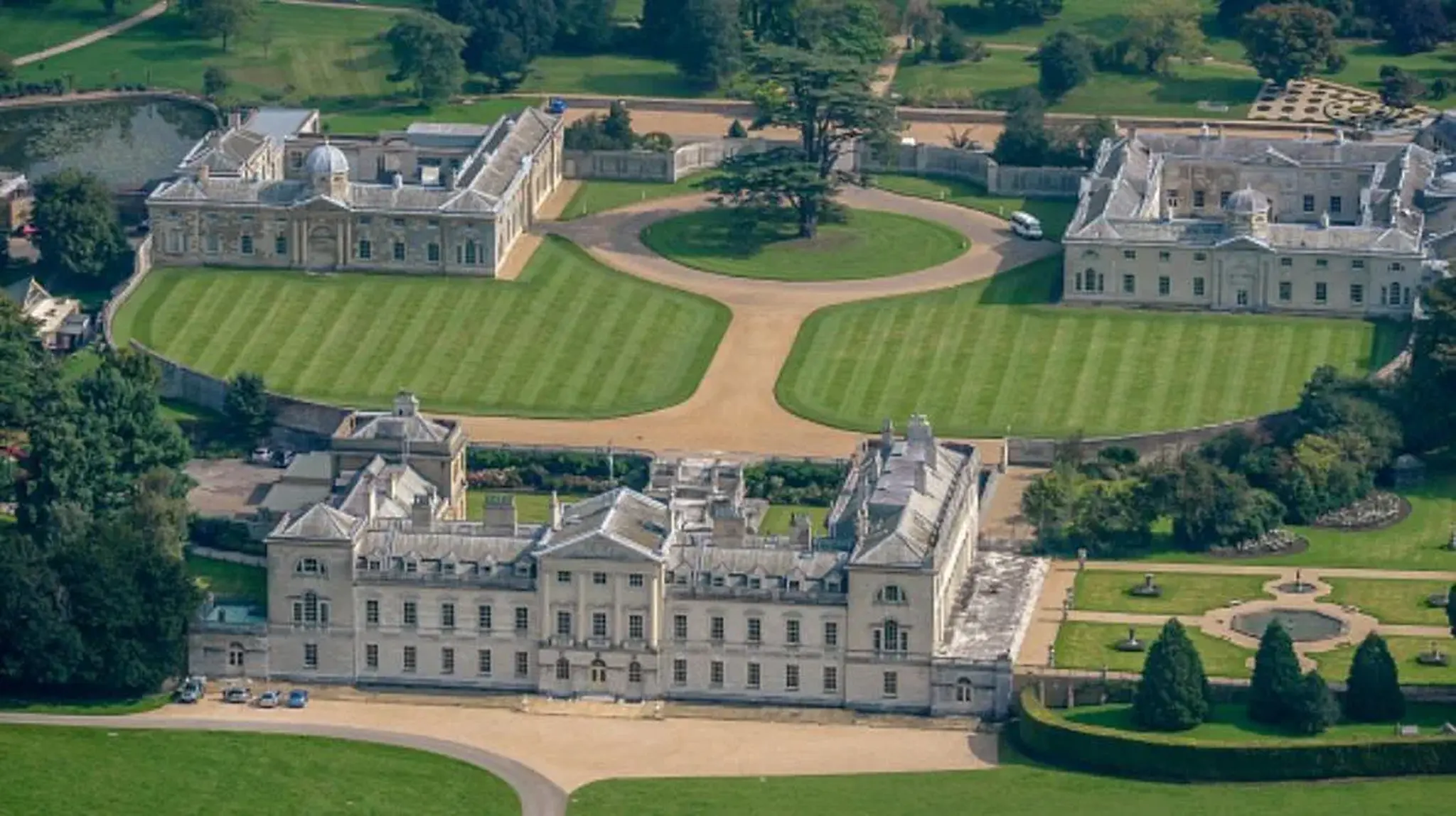 Aerial view of an elegant estate with two large, symmetrical classical buildings