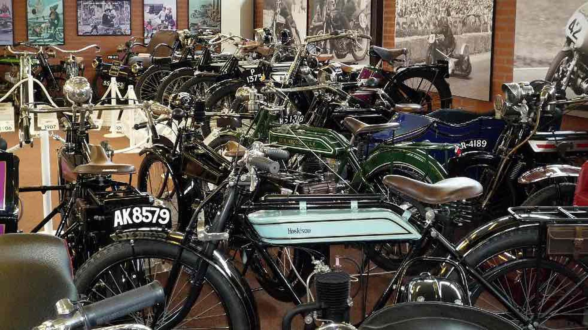 A collection of vintage motorcycles displayed closely together in the National Motorcycle Museum