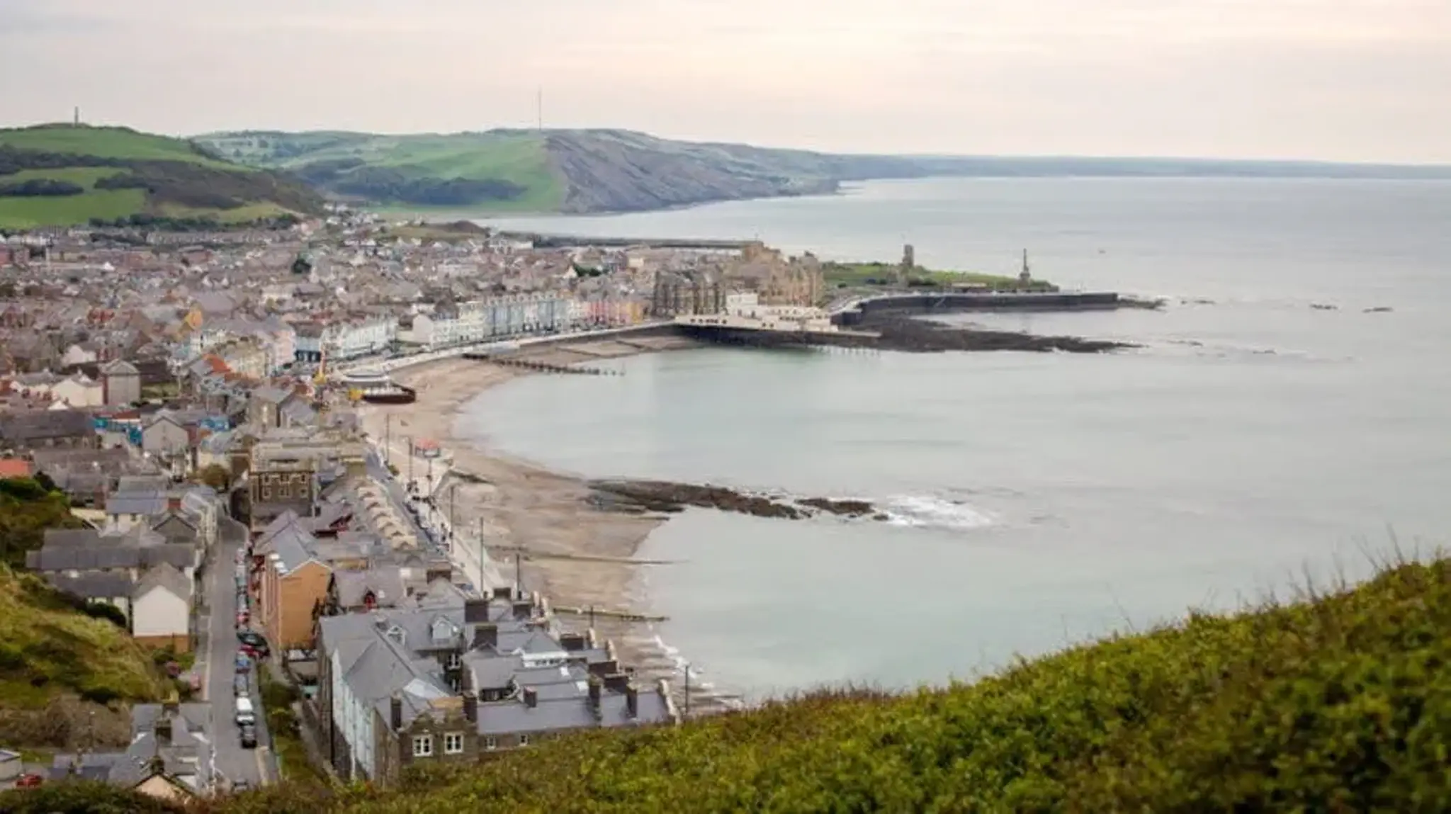A coastal town by the sea, featuring a sandy beach