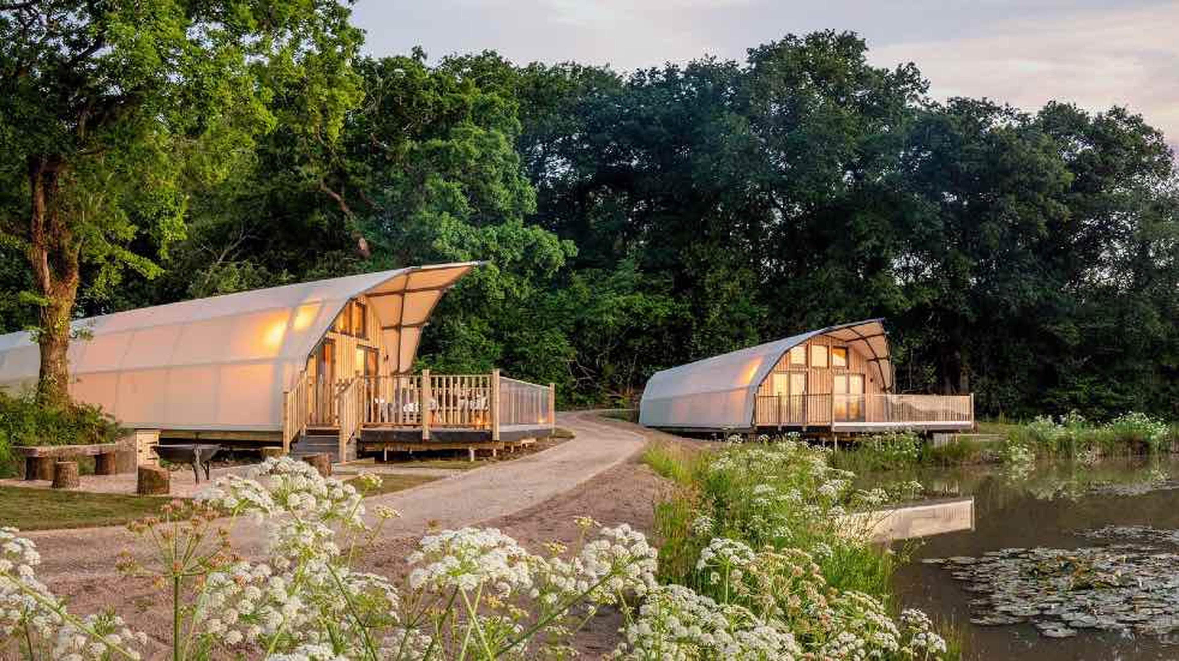 An image of two huts by a lake at a hoeseasons park