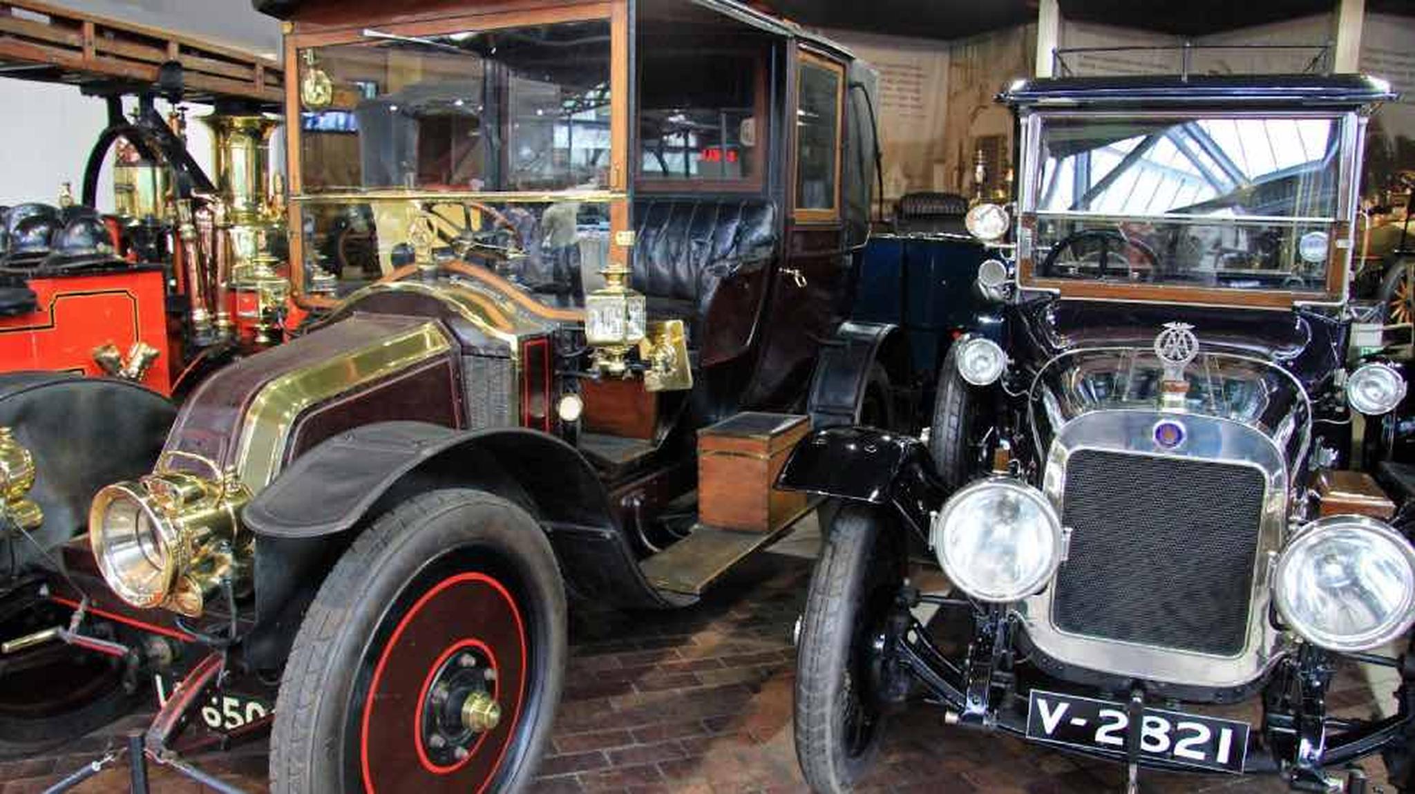 Two vintage cars with brass and leather details displayed in the National Motor Museum Beaulieu