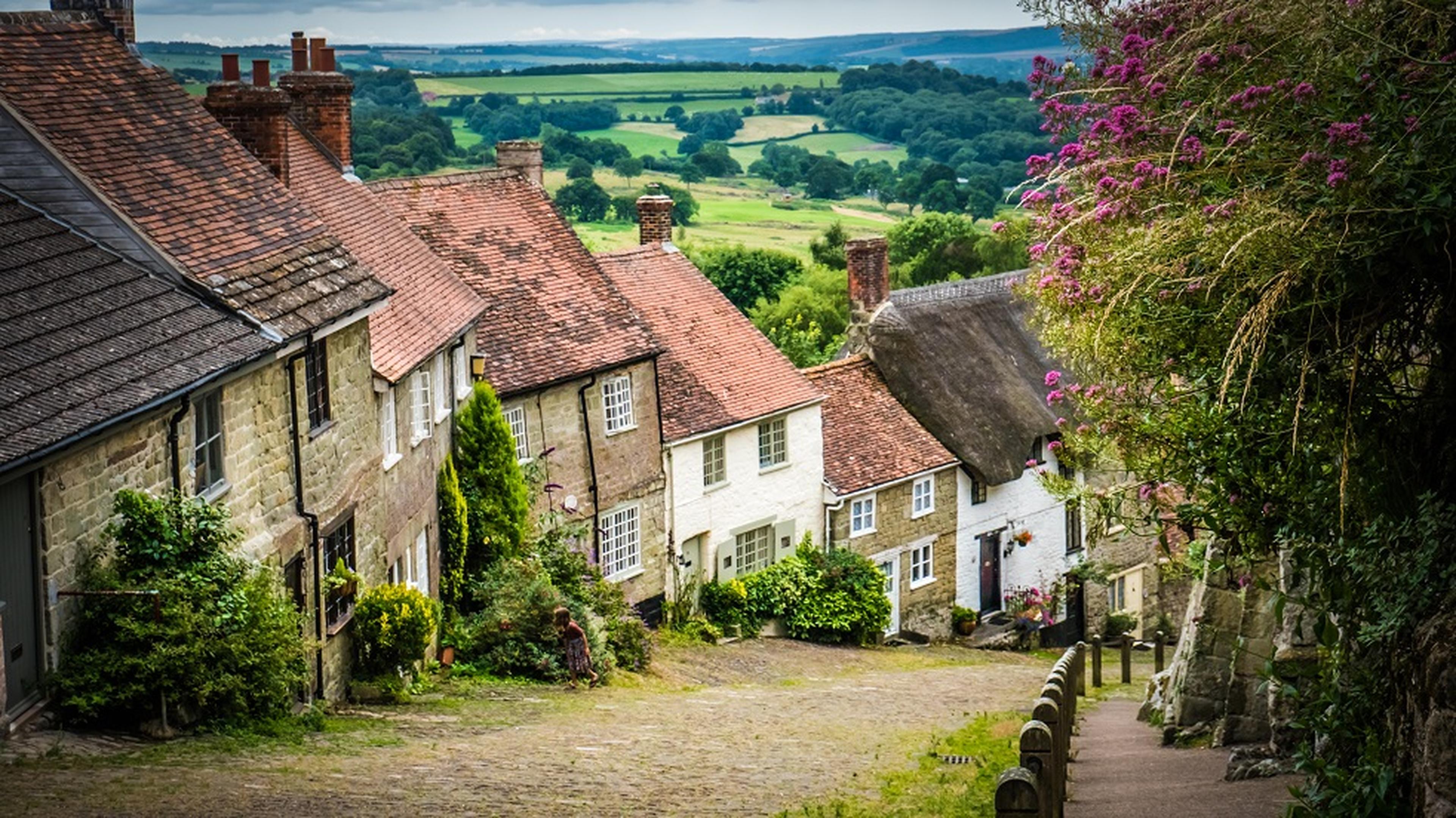 Steep cobblestone street lined with rustic cottages