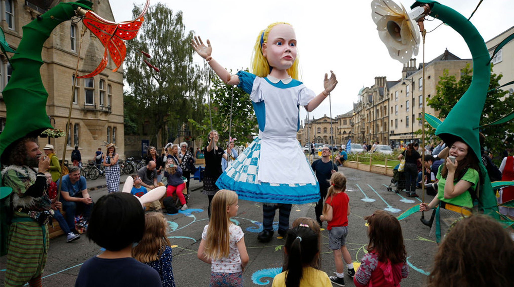 A giant Alice in Wonderland puppet during Alice's Day celebration in Oxford