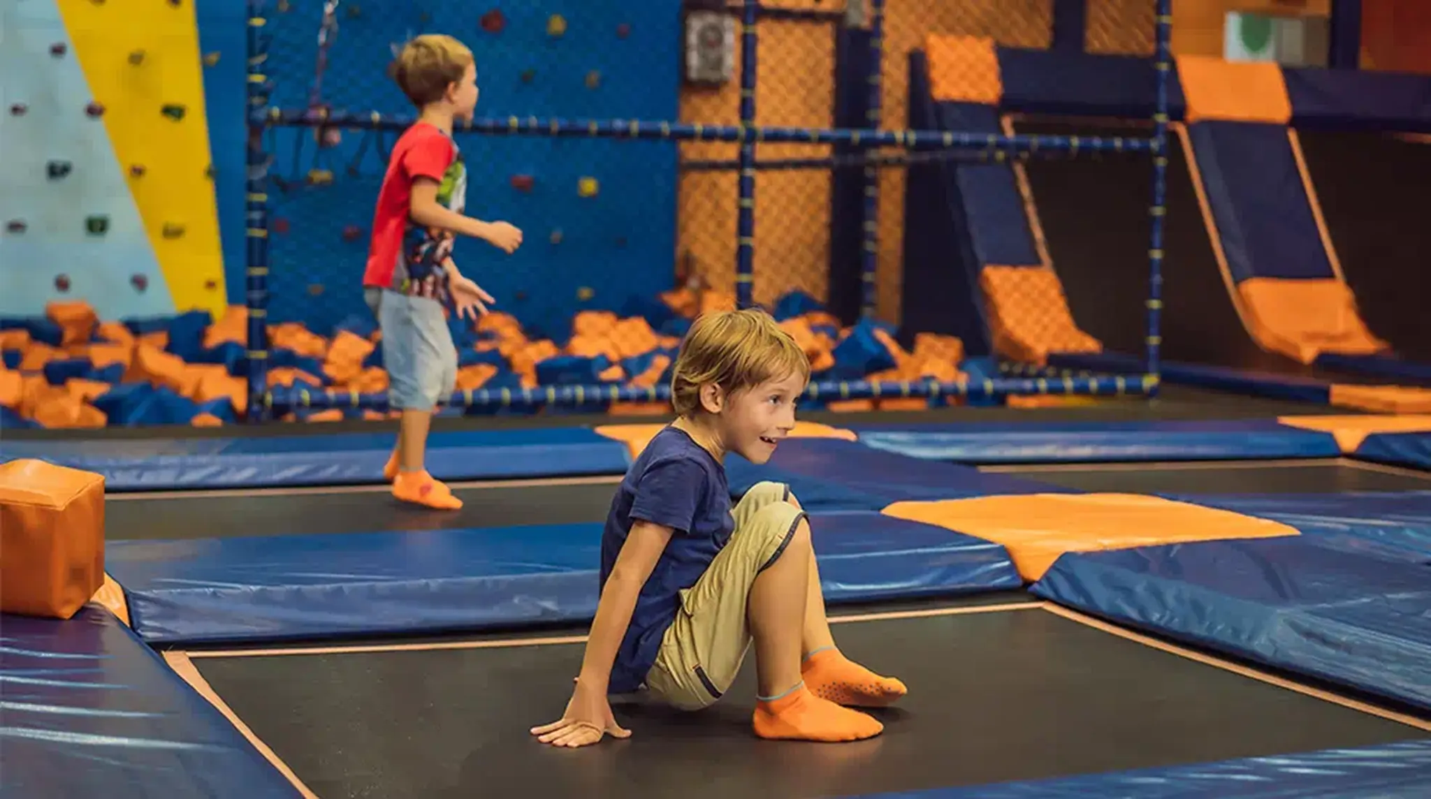 Two kids enjoying a trampoline park