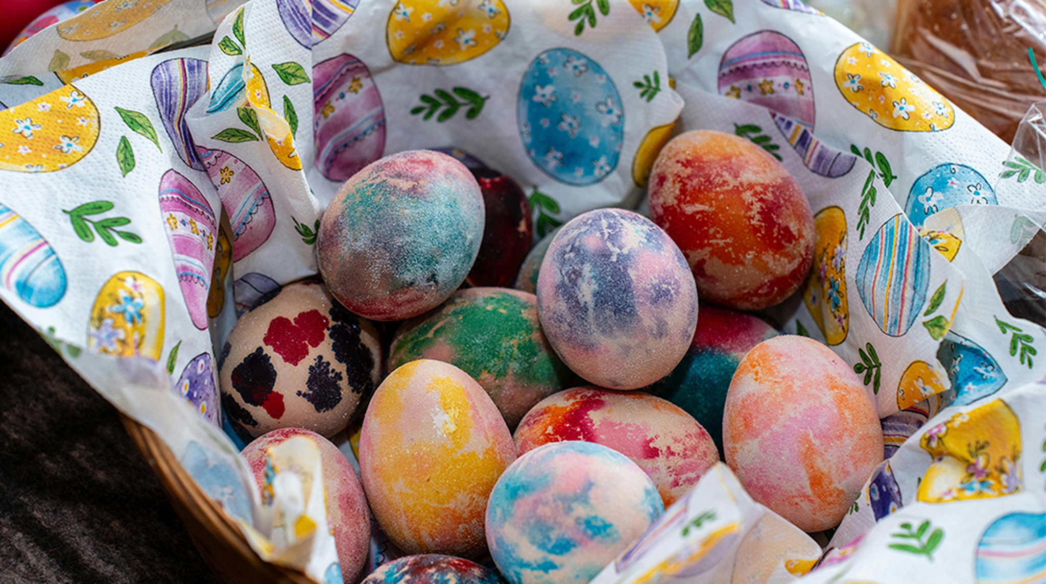 A basket of vibrantly dyed Easter eggs
