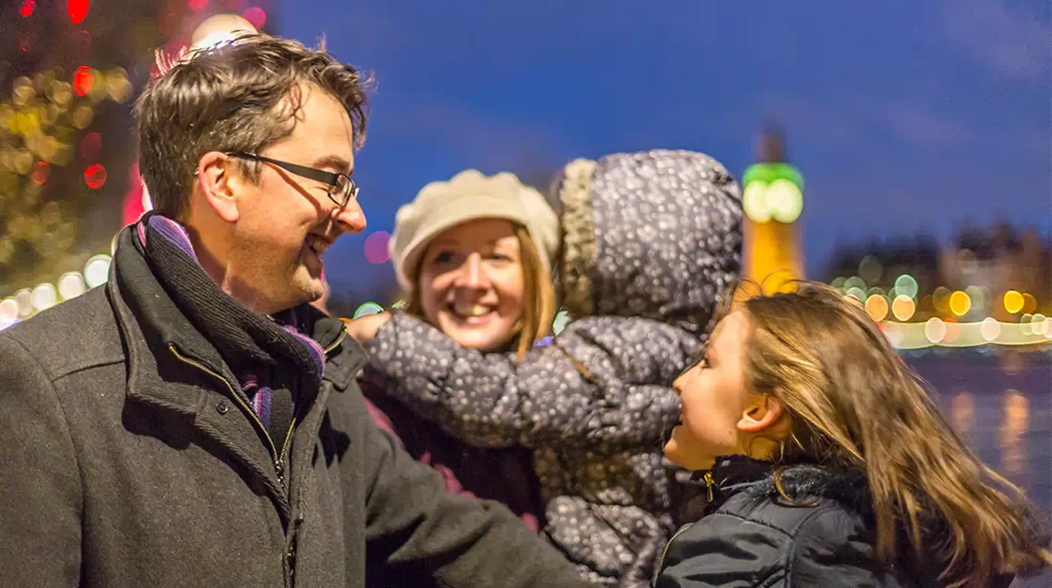 A family enjoys a joyful moment in a city at night