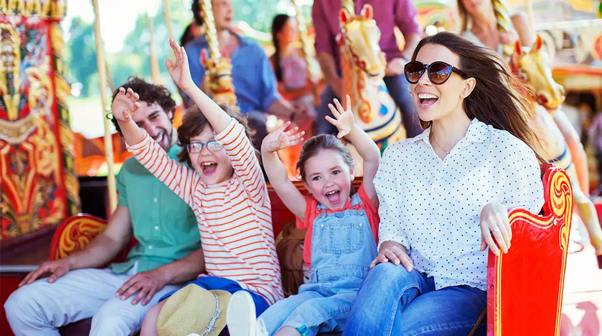 A happy family enjoys a carousel ride