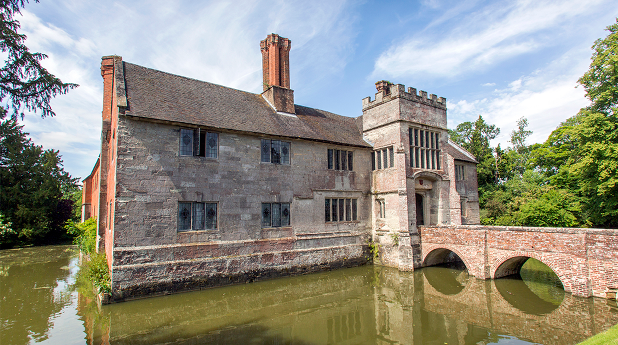 A tudor, timber-framed manor house with a moat and walled gardens, plus Elizabethan interiors.