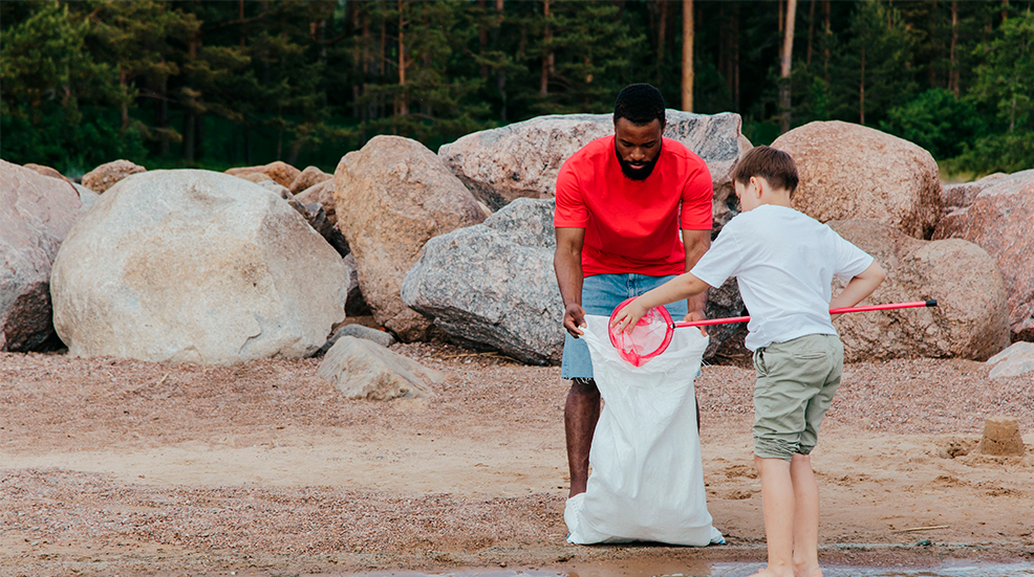 Man and boy doing beach clean