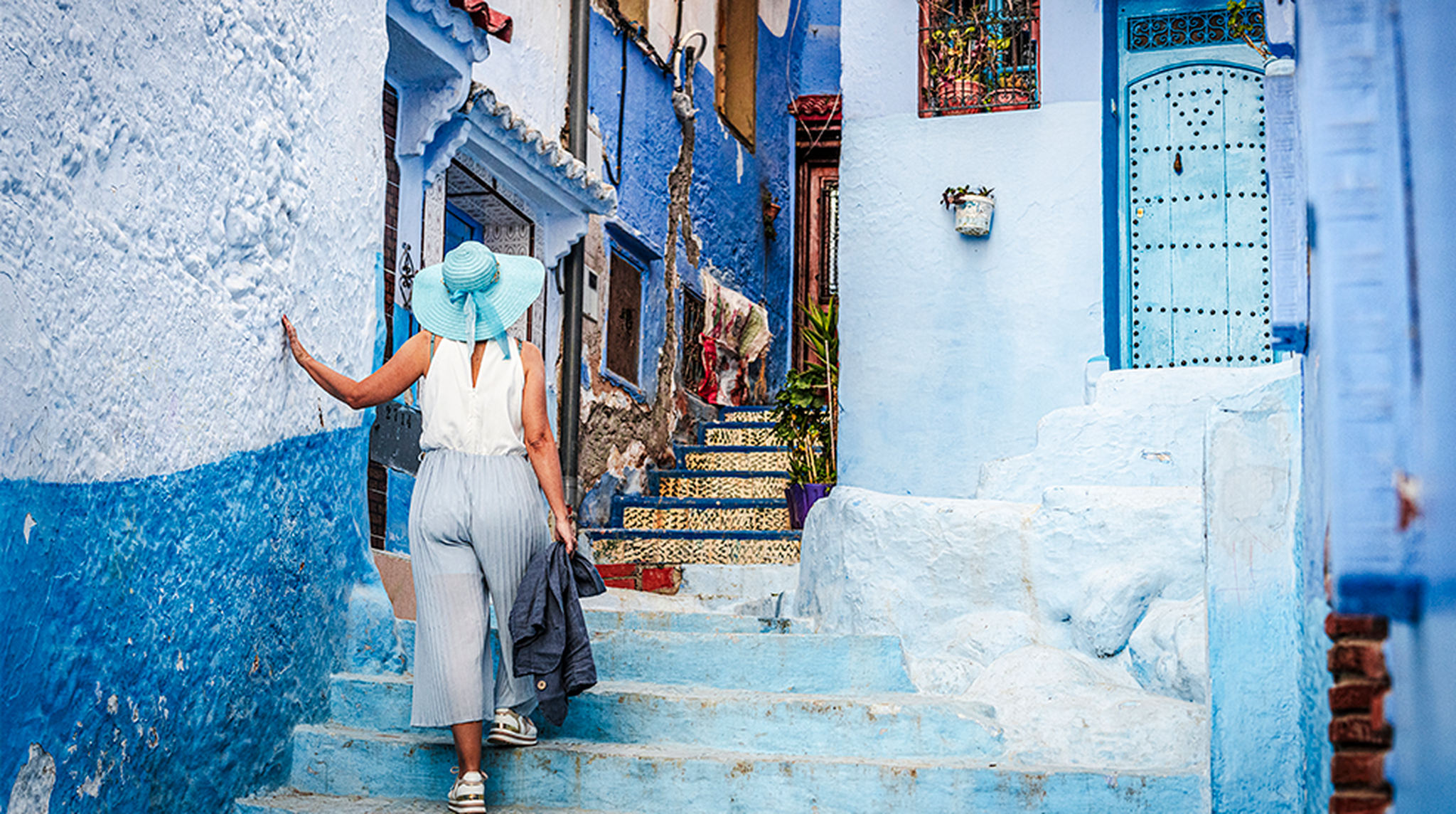 Charming woman walking in the blue town of Chefchaouen