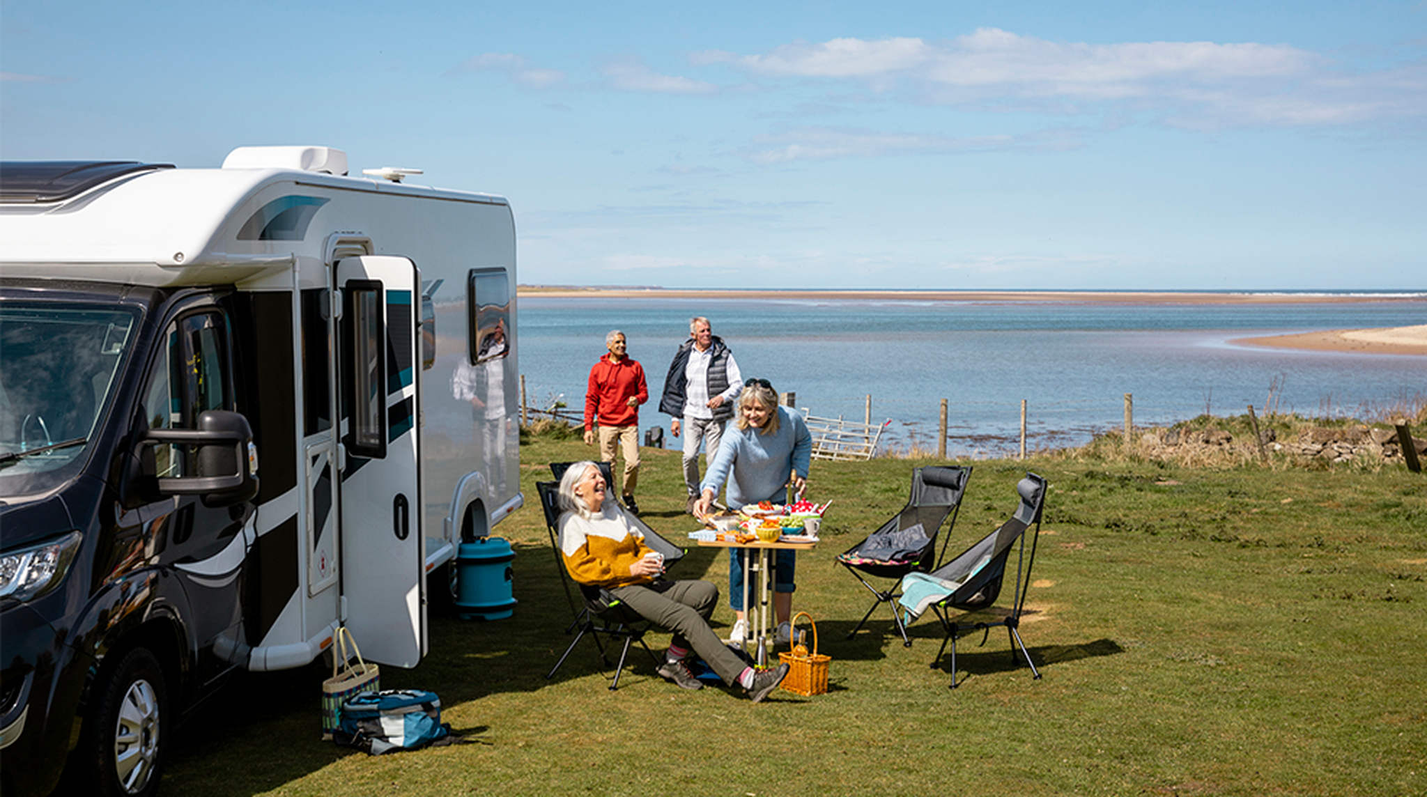 Senior couples on mobile home staycation by the coast