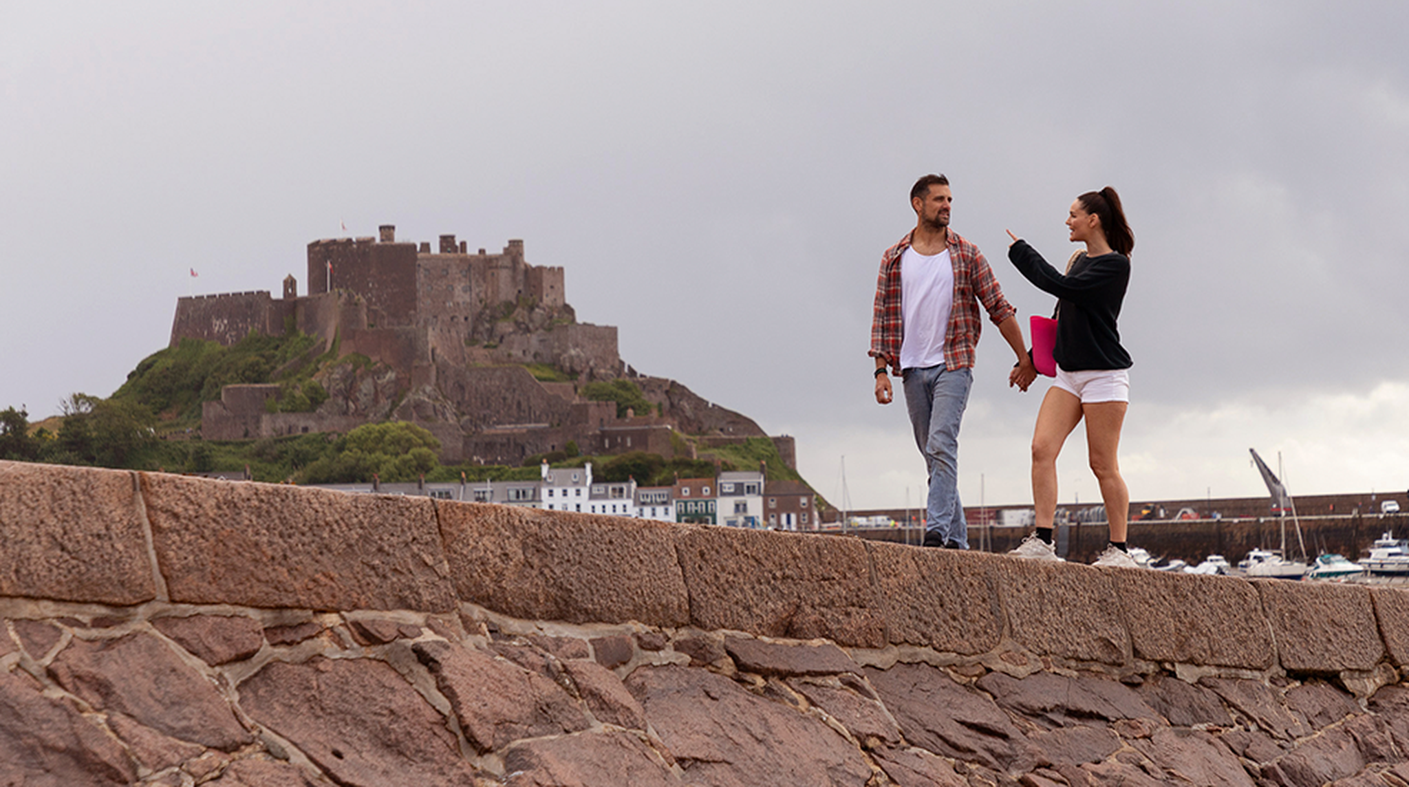 A couple walking along Jersey’s coast