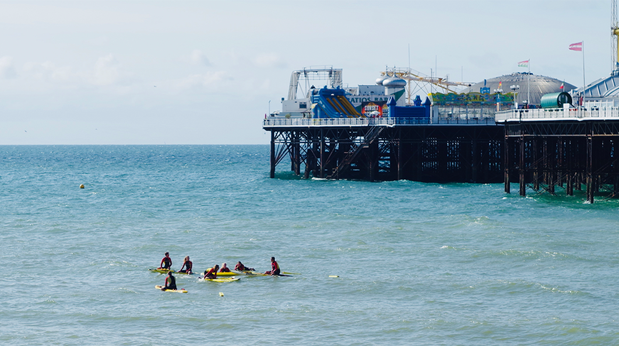 A group of Paddle boarders outside Brighton Palace Pier