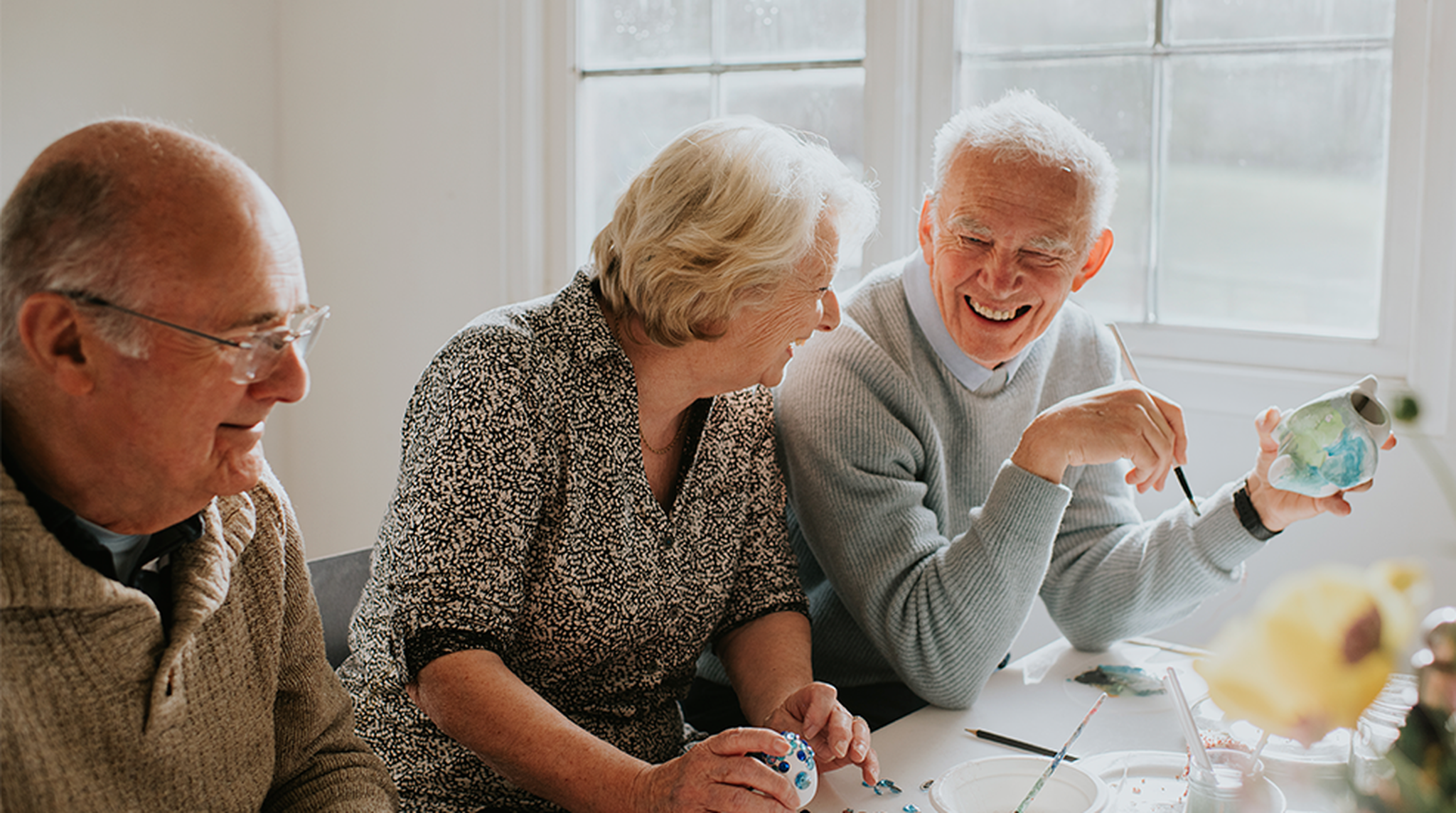 Elderly people painting together