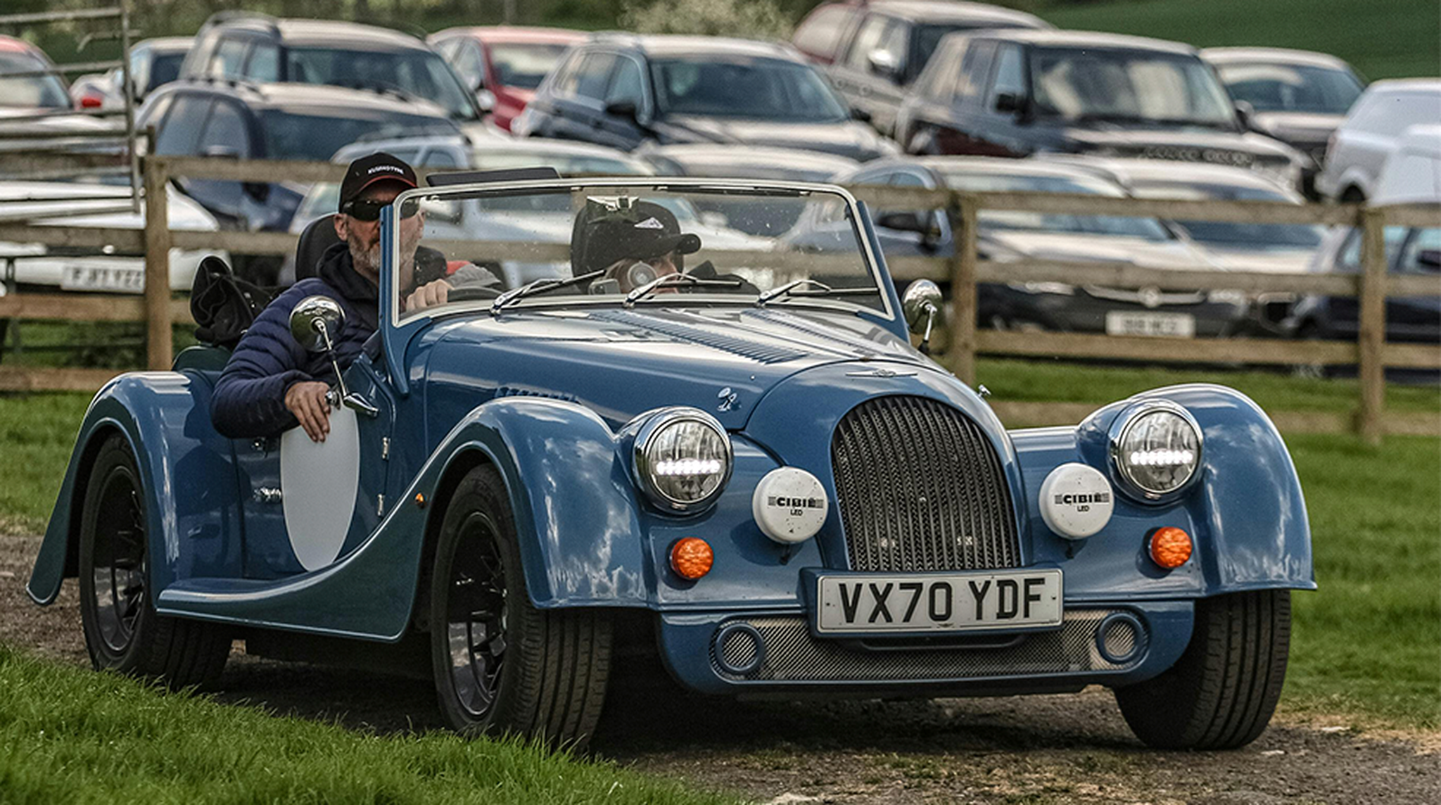 Man driving a blue classic car