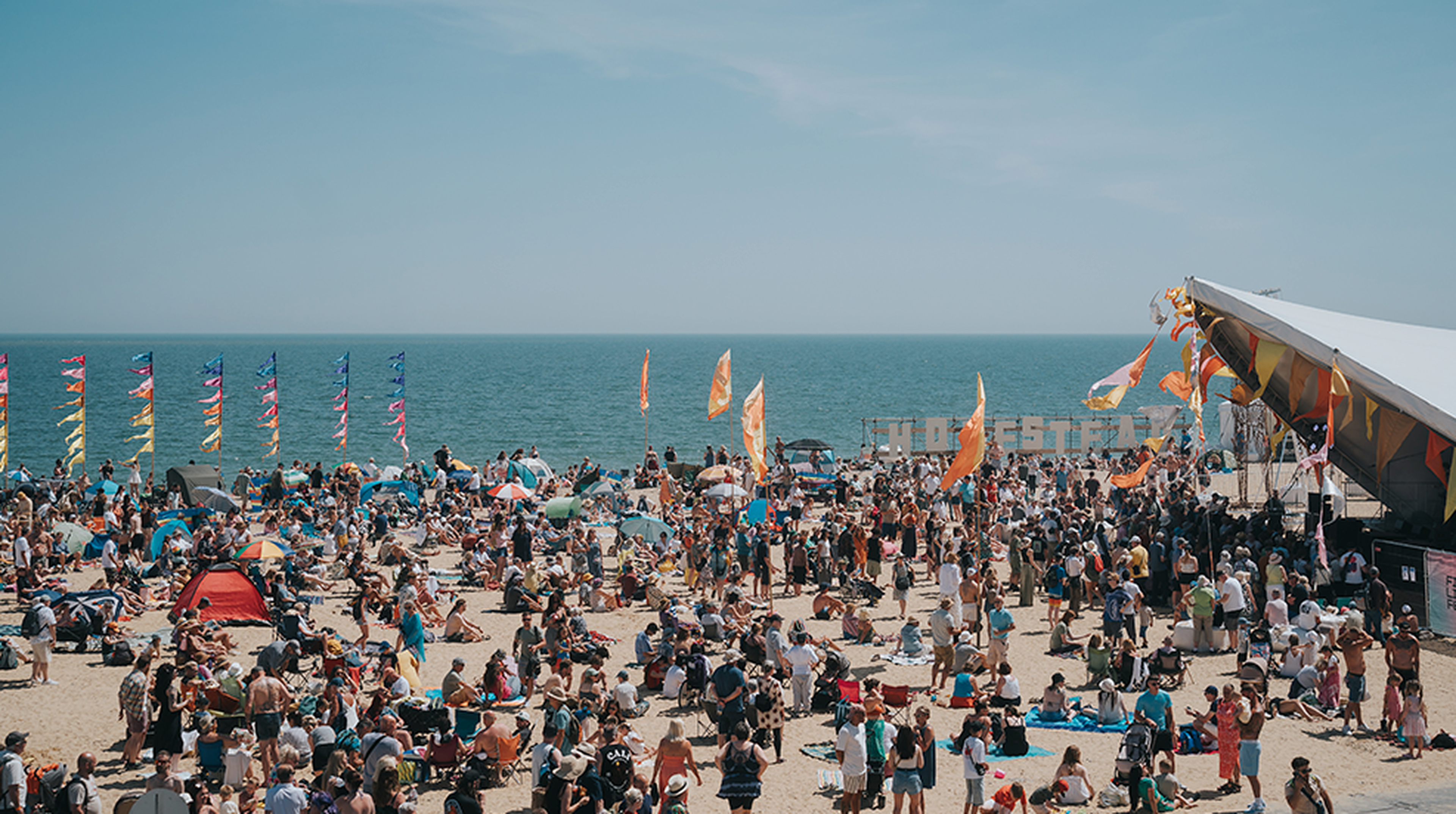 People gather on the beach  in East Sussex for the First Light Festival