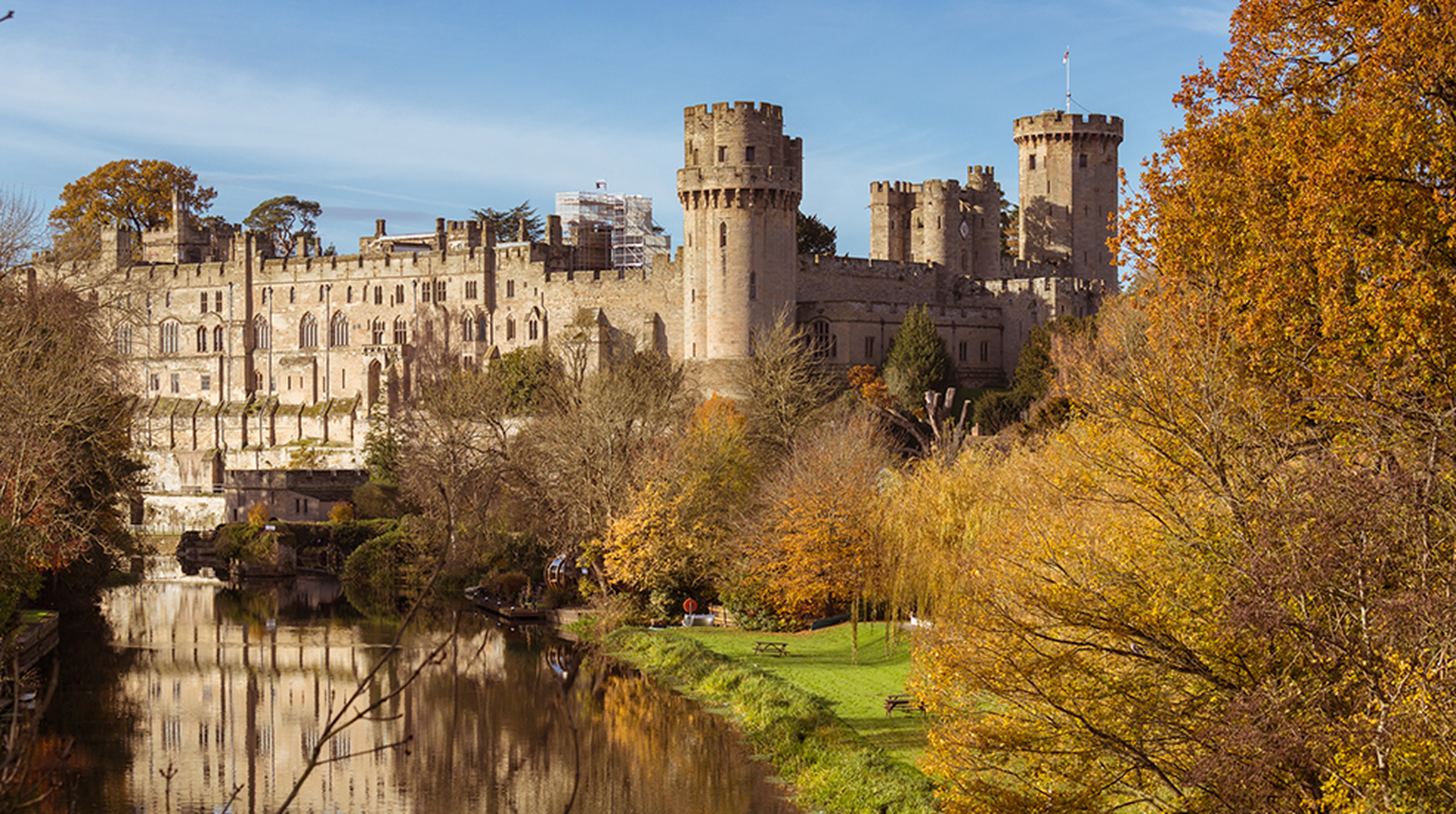 View of Warwick Castle across the river in the autumn