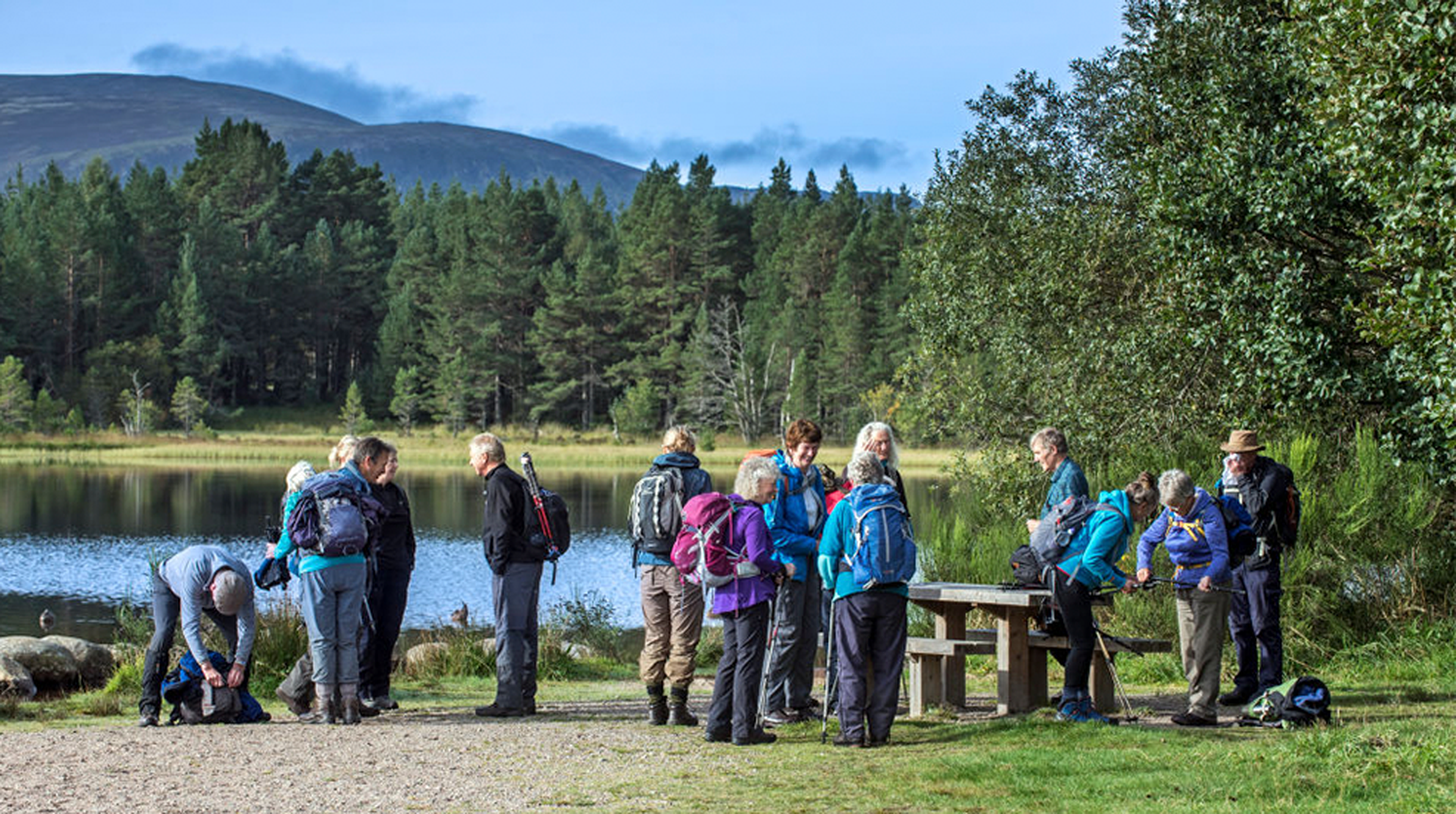 Elderly walkers meeting and preparing to go hiking along Loch Morlich.