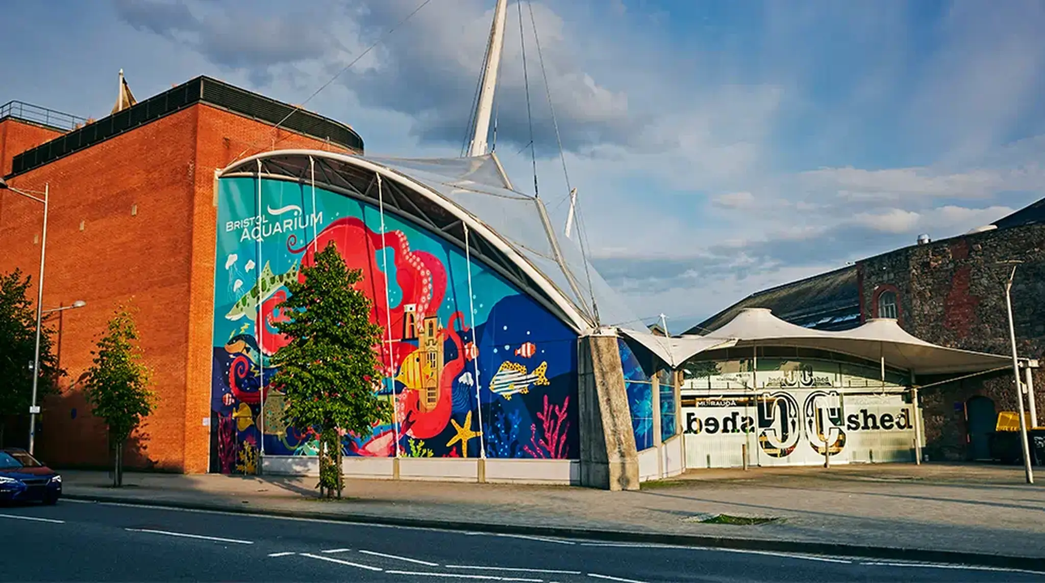 Exterior of a large aquarium with colourful mural