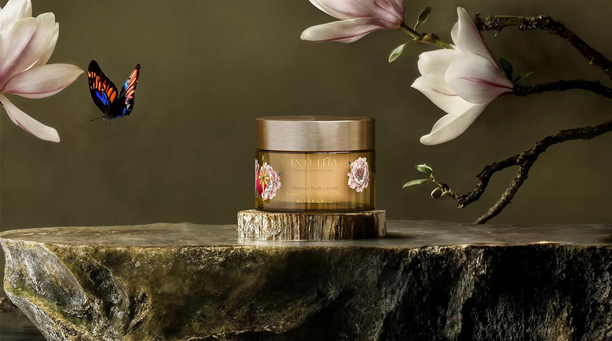 A jar of Intuitia beauty cream on a stone slab