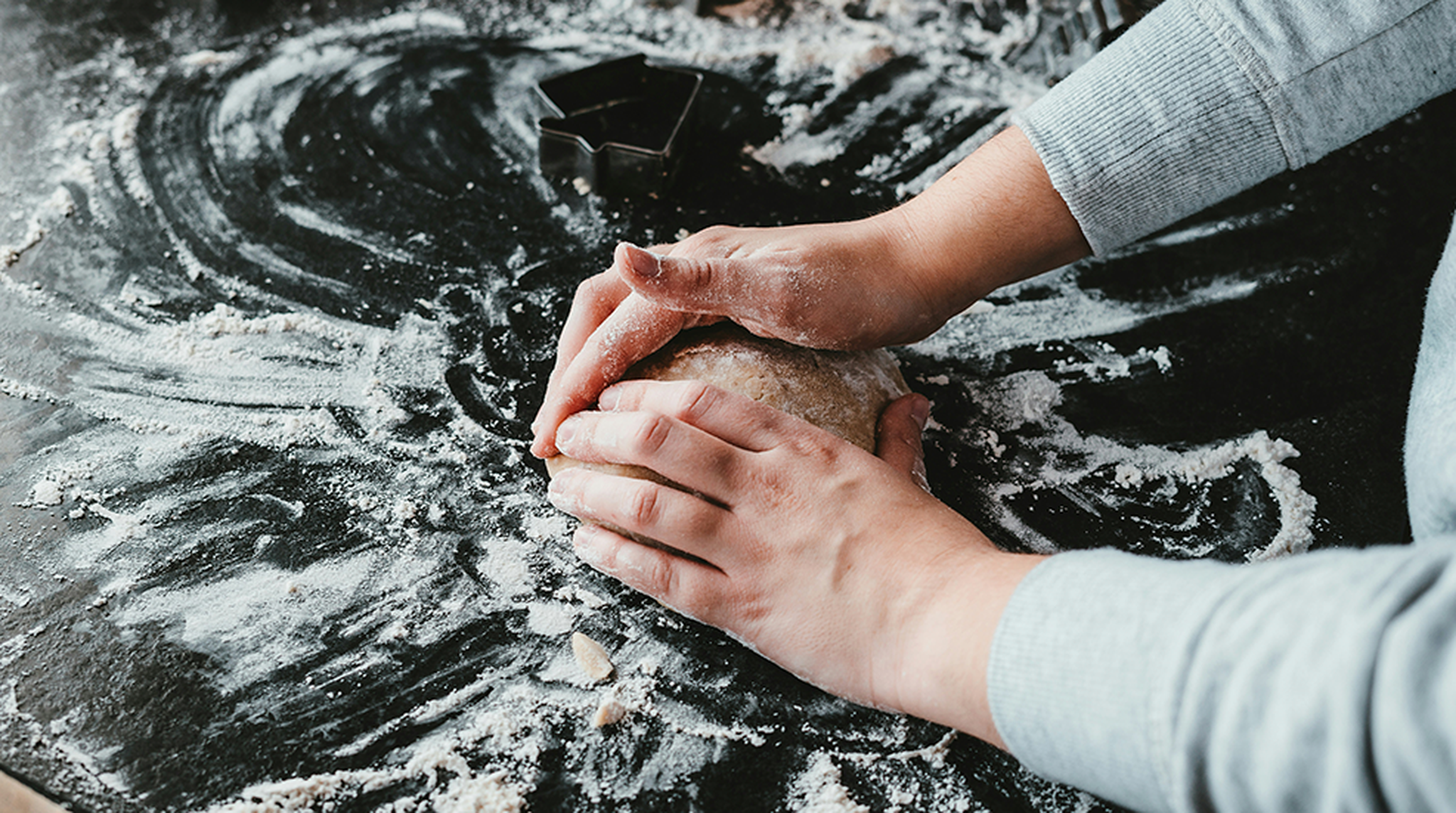 Close up of hands kneading dough