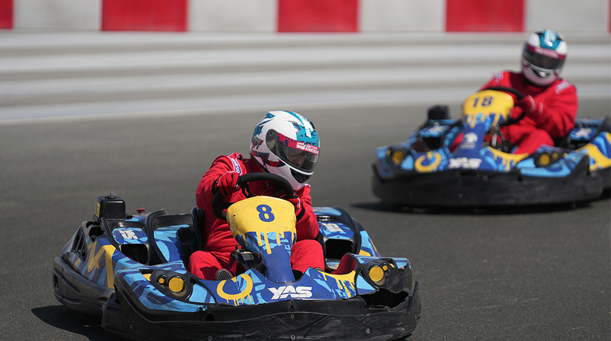 Dynamic go-kart racing action with two drivers speeding at Yas Marina Circuit, Abu Dhabi.
