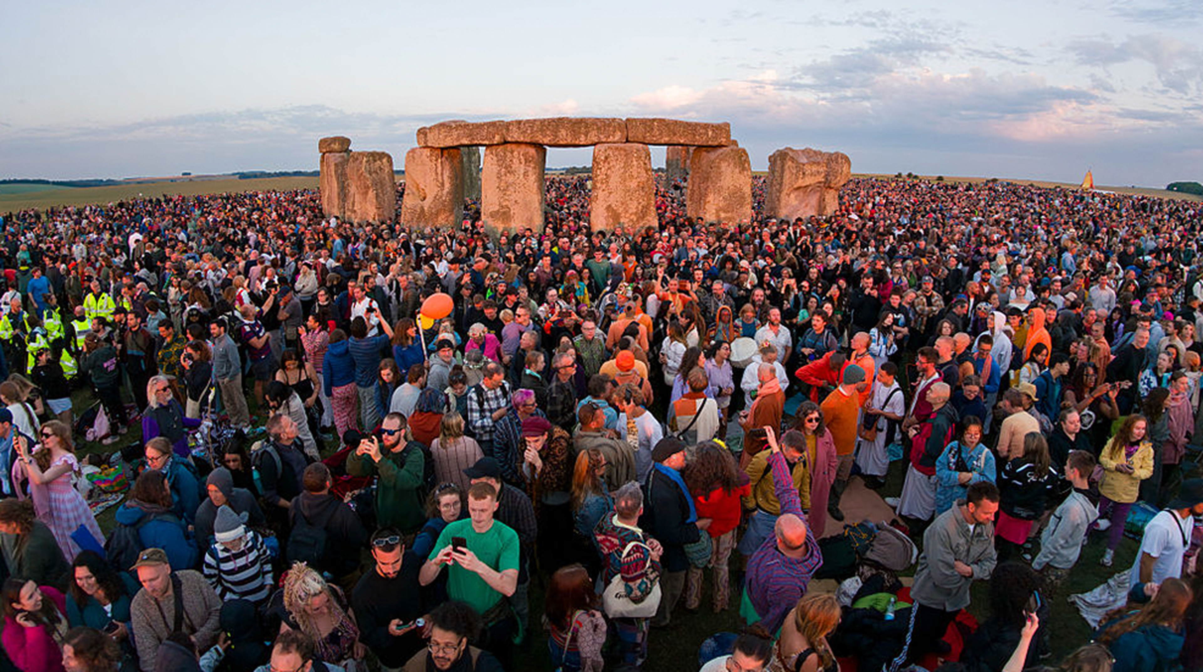 Visitors enjoy the sunrise during celebrations of the summer solstice at Stonehenge