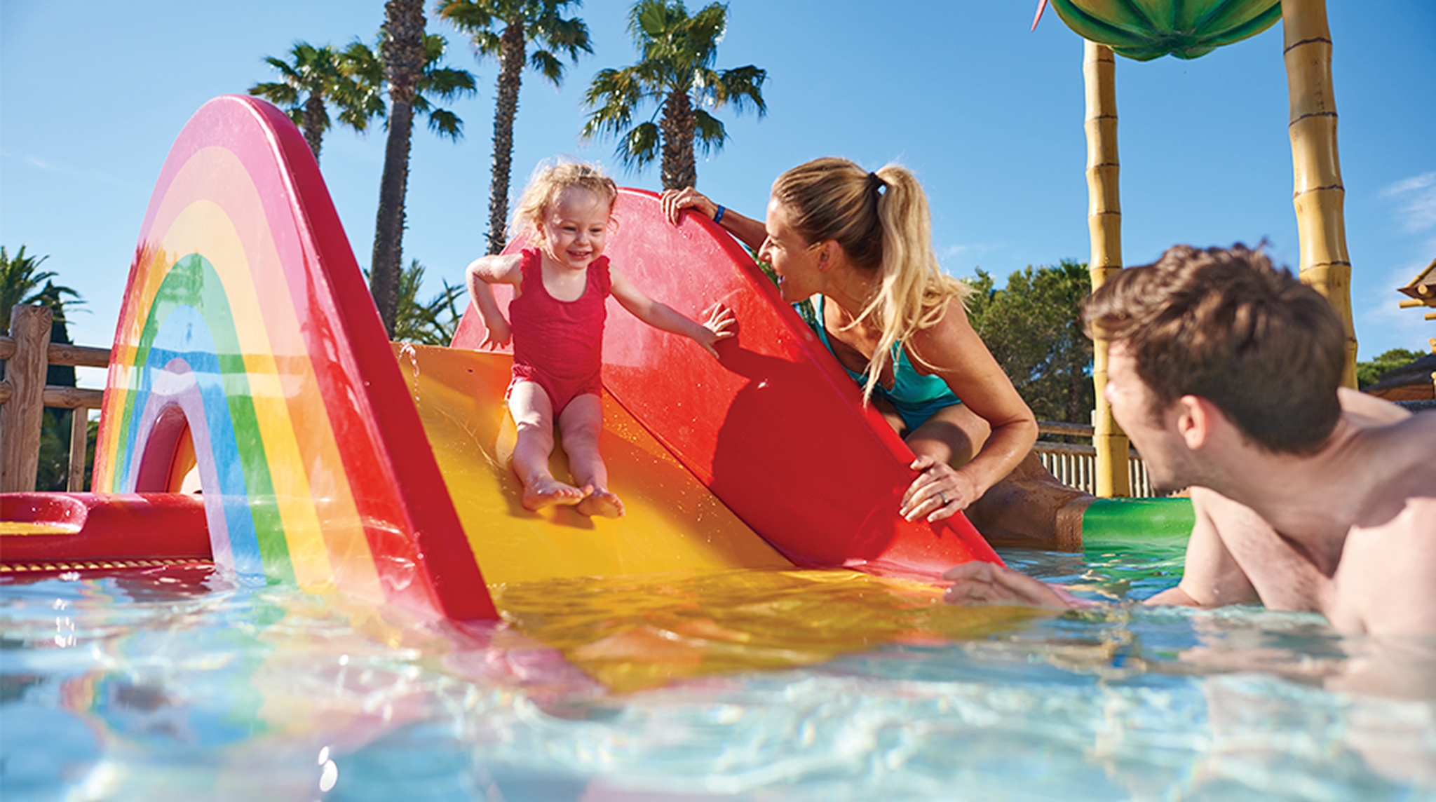 Little girl on slide in a pool