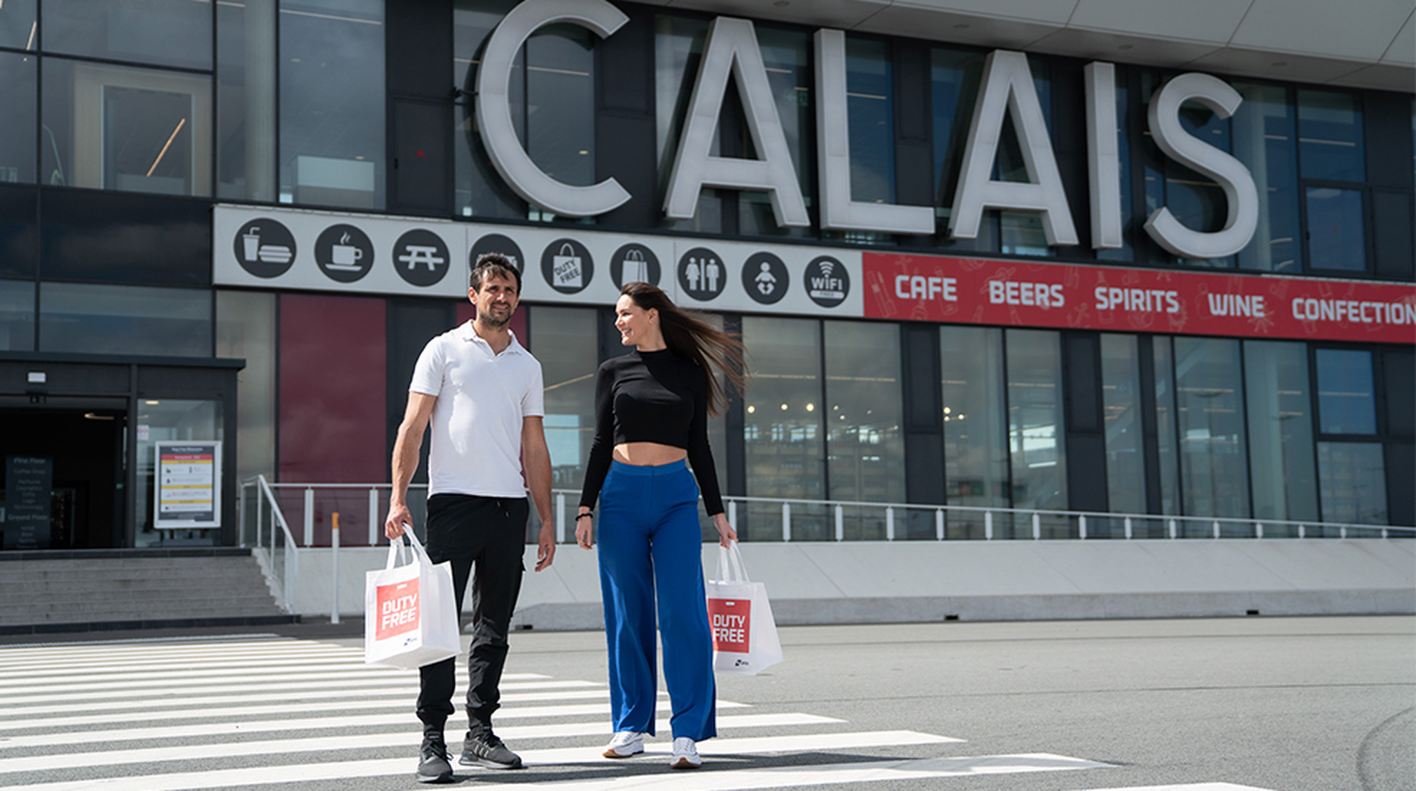A couple arriving at Calais with duty free bags