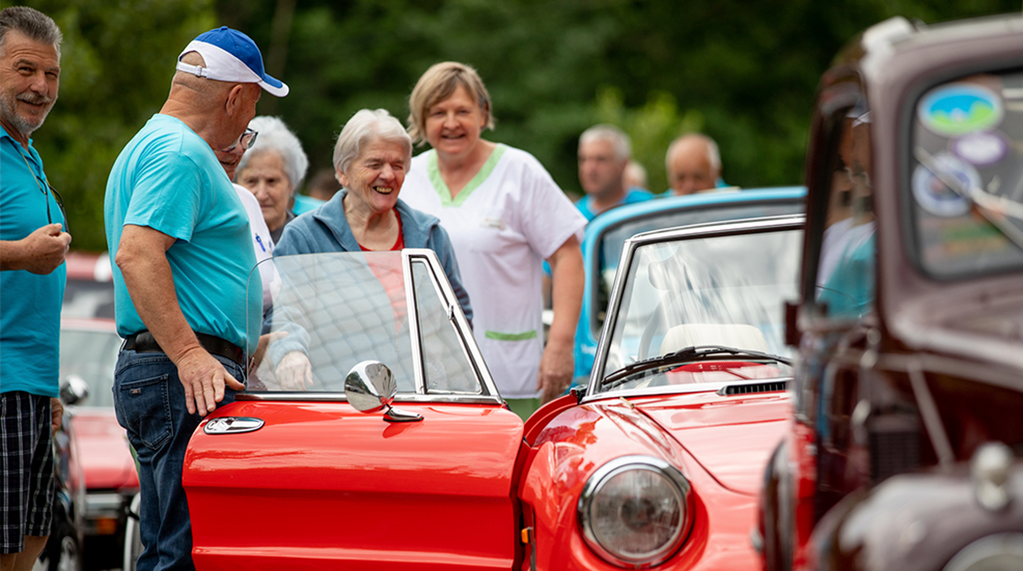 Elderly people looking at classic cars