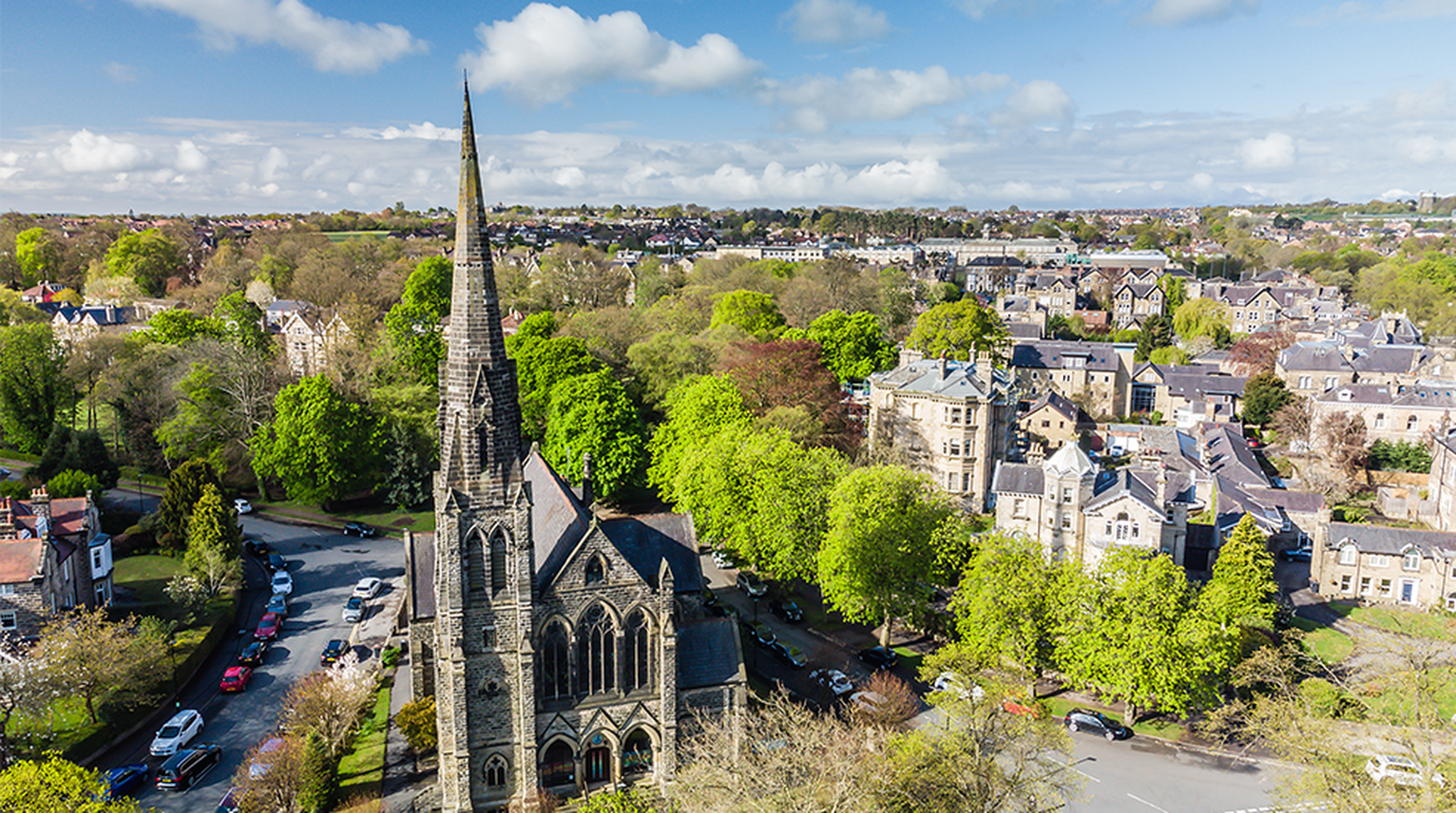 Aerial view of a church building and residential housing in the city centre of Harrogate, North Yorkshire, England