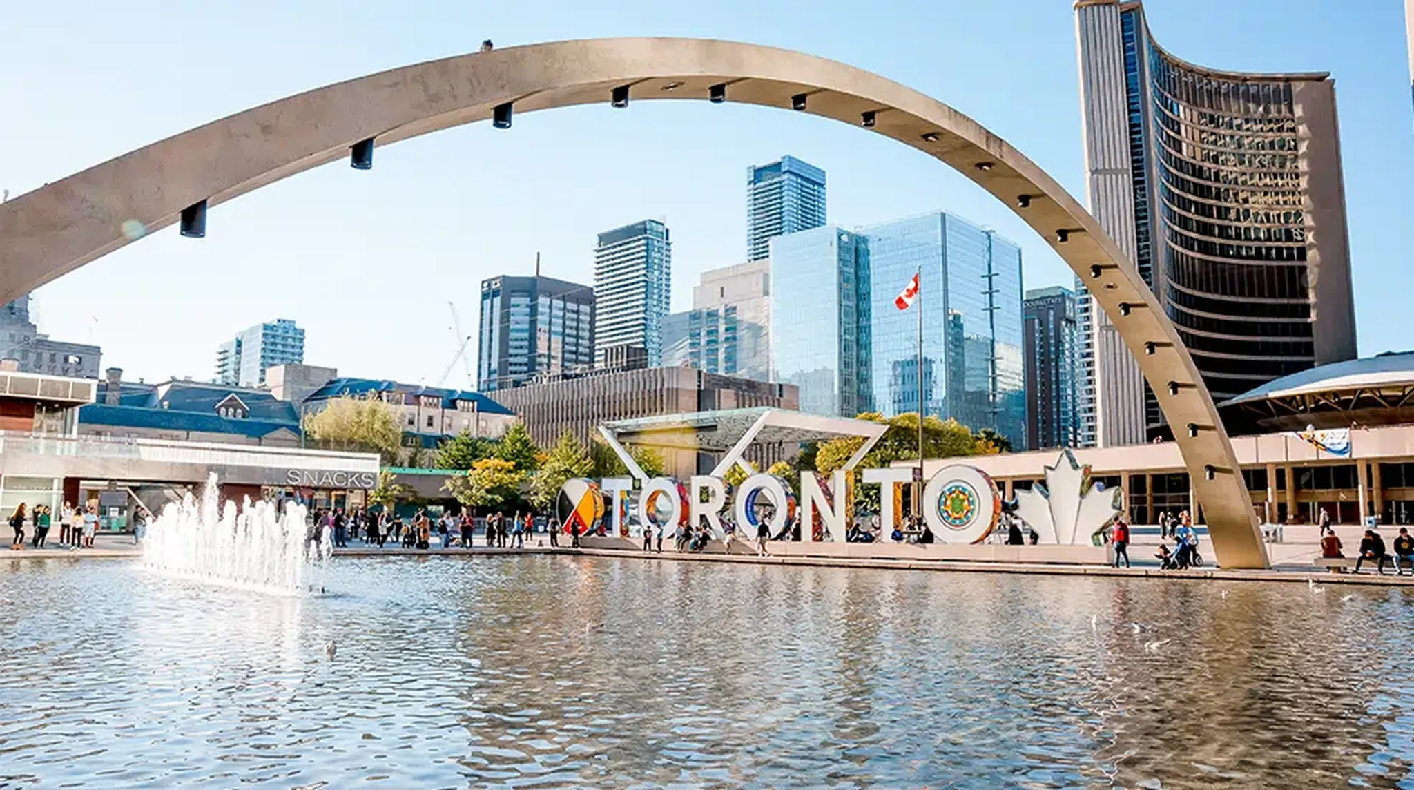 Toronto cityscape featuring Nathan Phillips Square, with the iconic Toronto sign