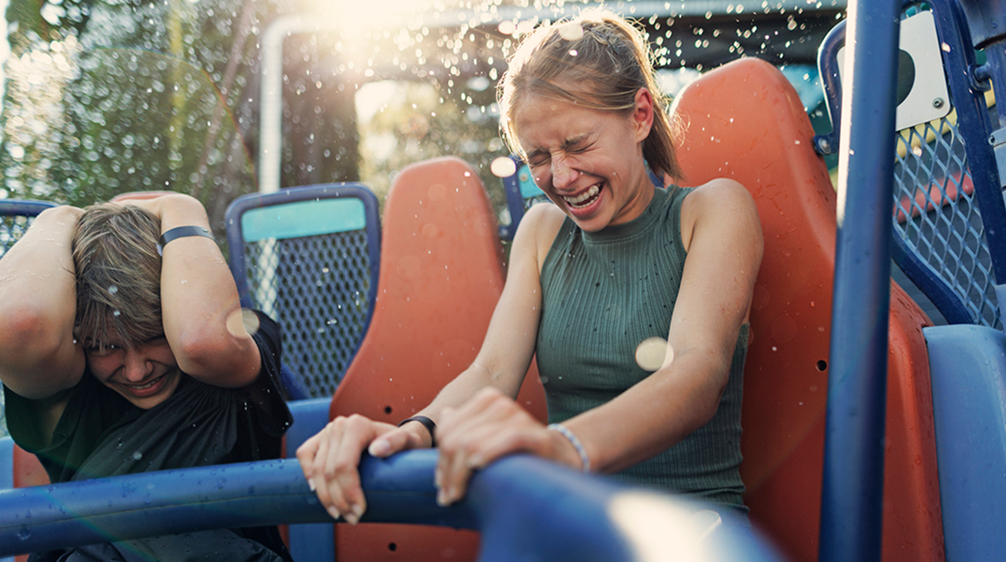 Teenage kids having fun in a circular rafts in amusement park.